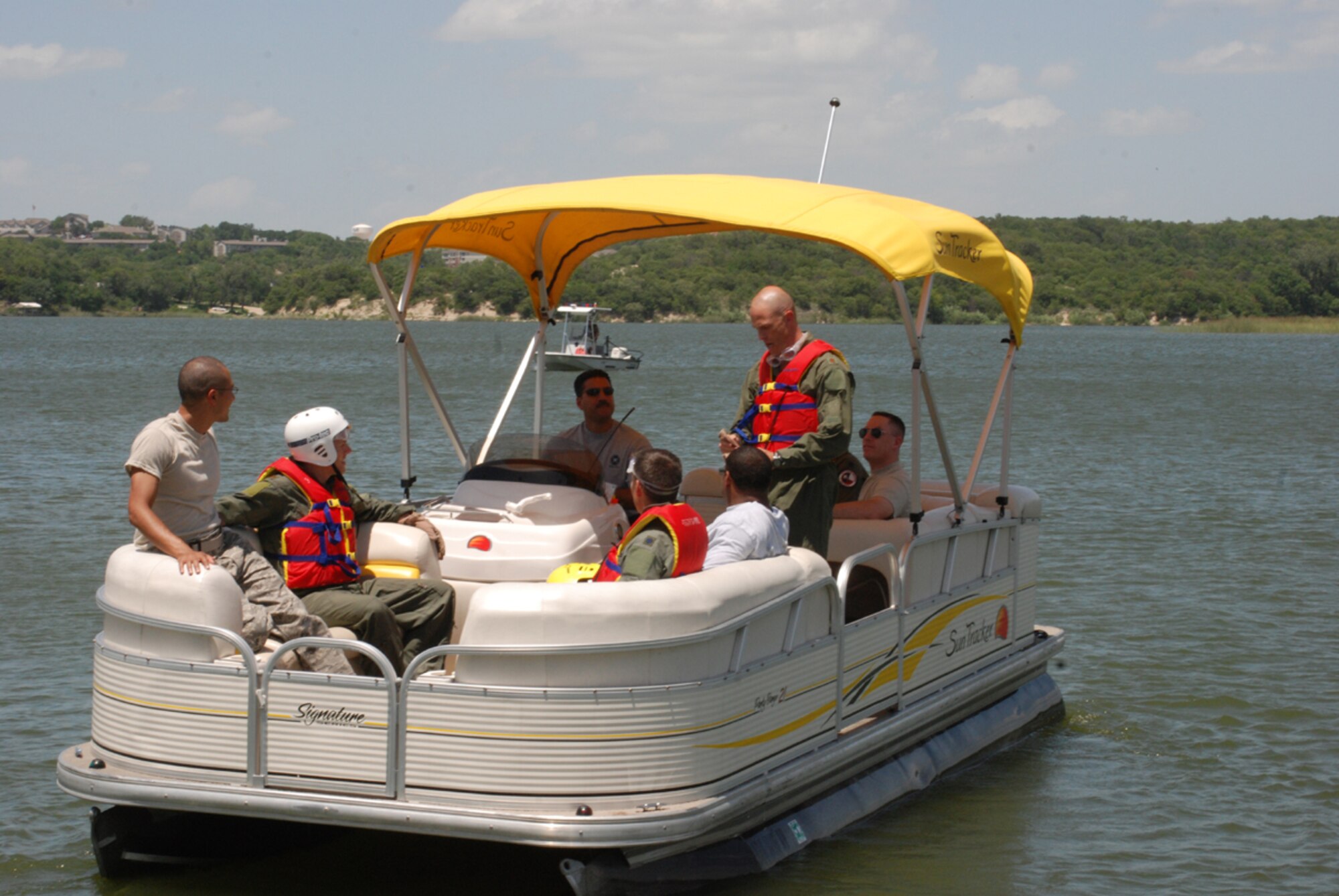 Pilots from the 457th Fighter Squadron, Naval Air Station Fort Worth Joint Reserve Base, Texas, are ferried out to their "drop point" on Lake Worth July 11. There they will simulate being rescued by members of the 305th and 306th Rescue Squadron, Davis-Monthan Air Force Base, Ariz. This training is the first time the pilots will experience rescue via an actual HH-60 "Pavehawk." (U.S. Air Force Photo/SSgt Chris Bolen)