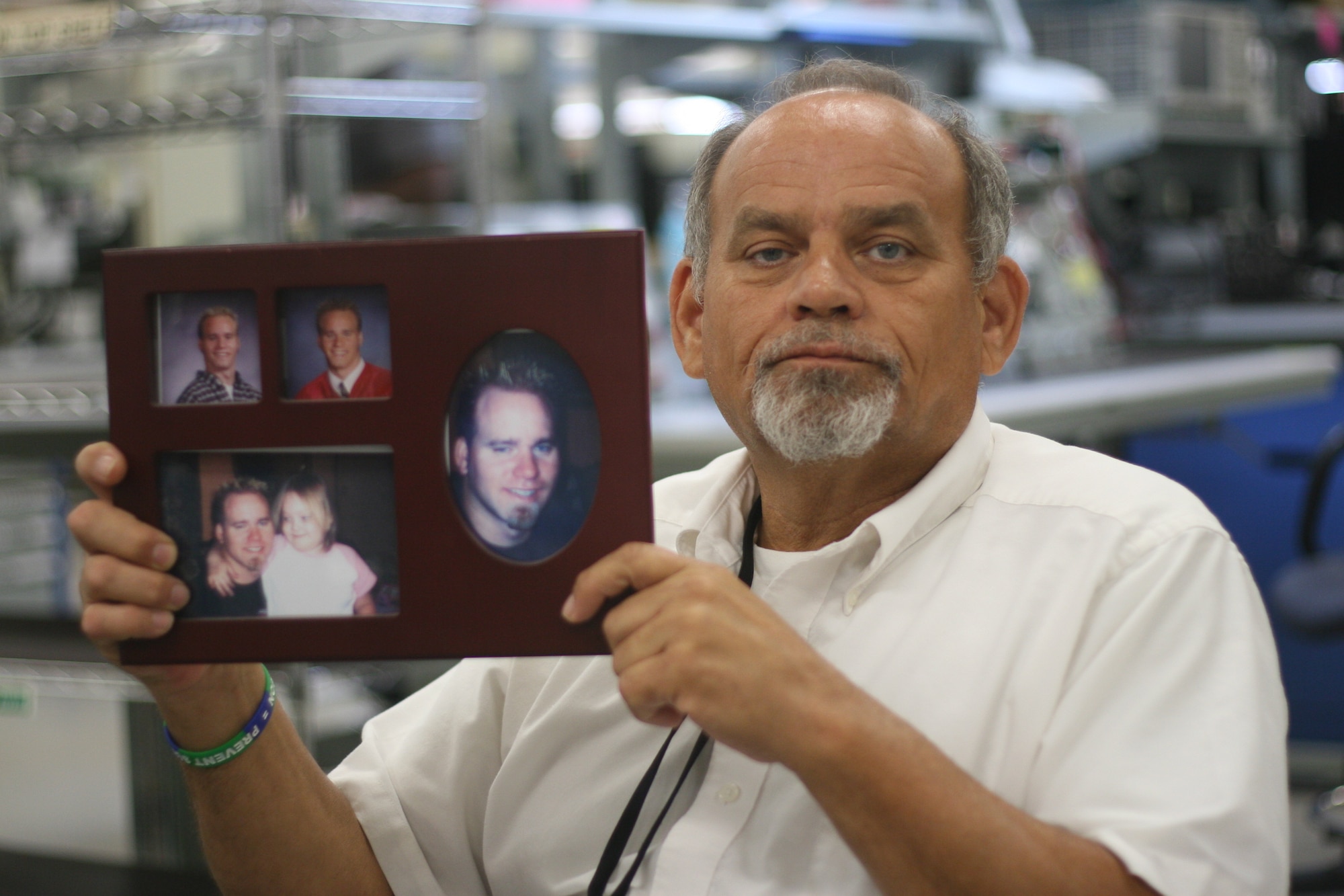 Rocky Dunham shows a picture of his son, Joey, who committed suicide more than two years ago. Since then, the tools and parts attendant in the 552nd Commodities Maintenance Squadron regularly speaks in the community about suicide prevention in the hope of sparing others from going through the pain of losing a loved one. (Air Force photo by John Stuart)