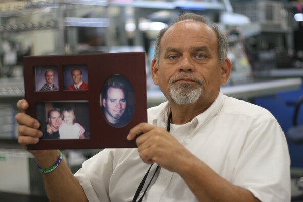 Rocky Dunham shows a picture of his son, Joey, who committed suicide more than two years ago. Since then, the tools and parts attendant in the 552nd Commodities Maintenance Squadron regularly speaks in the community about suicide prevention in the hope of sparing others from going through the pain of losing a loved one. (Air Force photo by John Stuart)