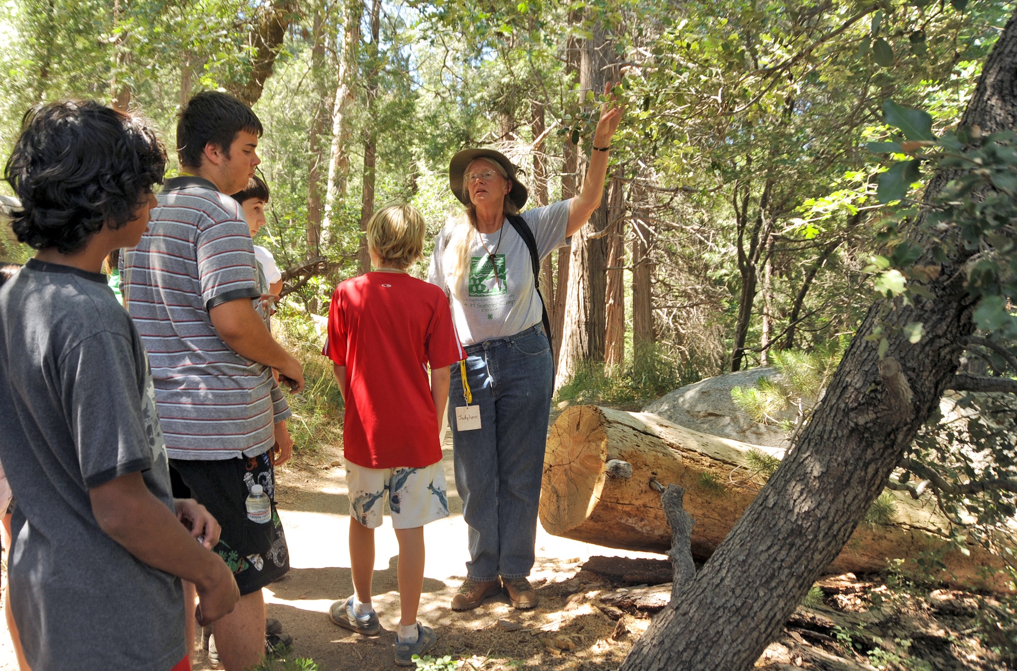 Judy Lynn Pelling, camp resource and nature counselor, leads 4-H campers on a nature hike to identify the area’s floral and fauna. (Photo by Joe Juarez)