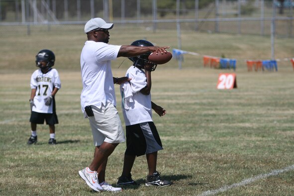 Coach Tracey Walker offers some pointers to one of his defensive linemen Aug. 21 during a scrimmage in Oklahoma City. The Gerrity Fitness and Sports center recreation assistant has been coaching sports for 17 years and uses sports as a way to build character among his players. (Air Force photo by John Stuart)