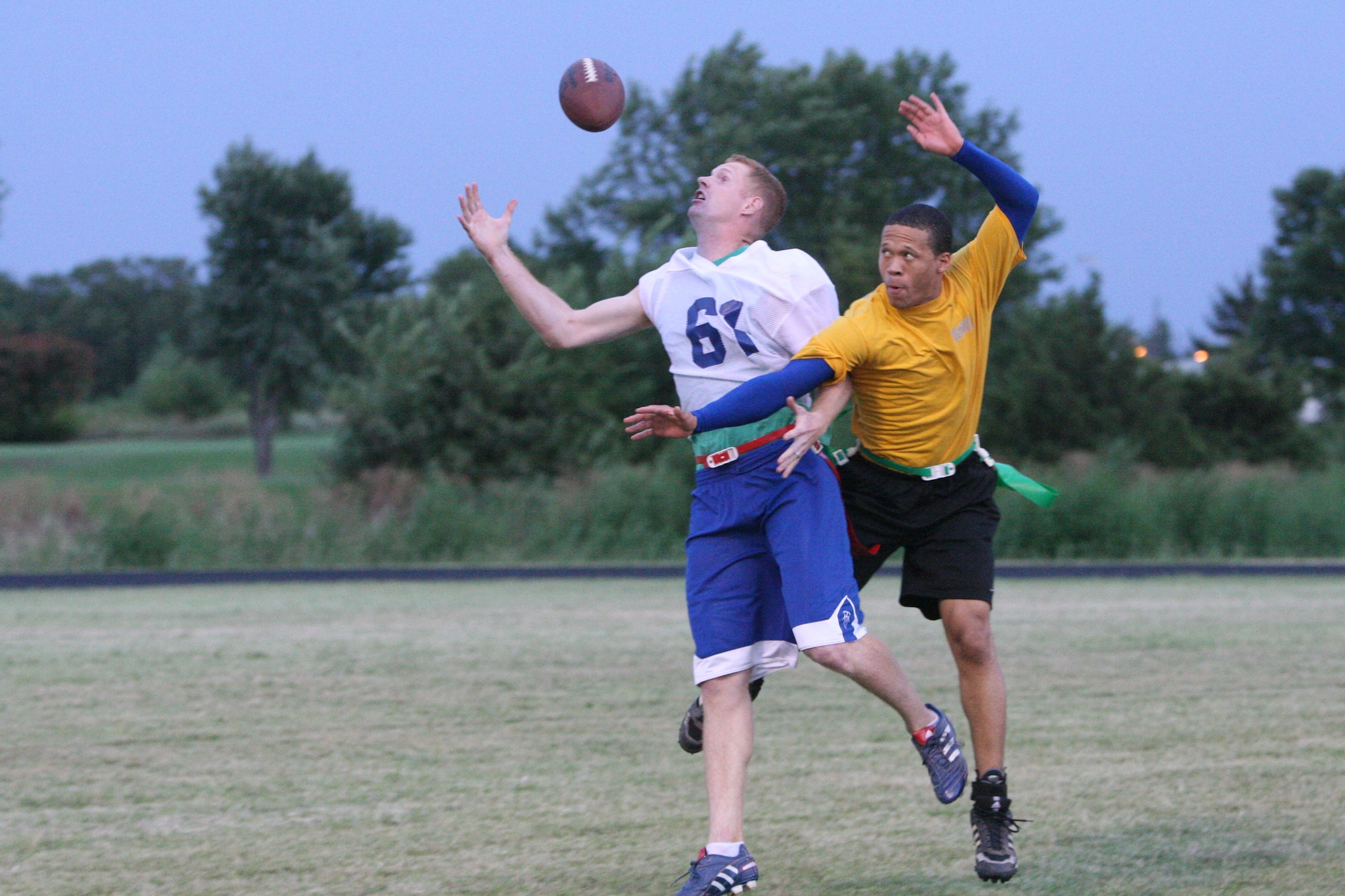 Reserve White’s Brandon Thompson, left, struggles to haul in a pass against CSD defender Brandon Collier Tuesday night. Reserve White narrowly topped the Sailors 21-16, closing down the final week of regular season play. (Air Force photo by John Stuart)
