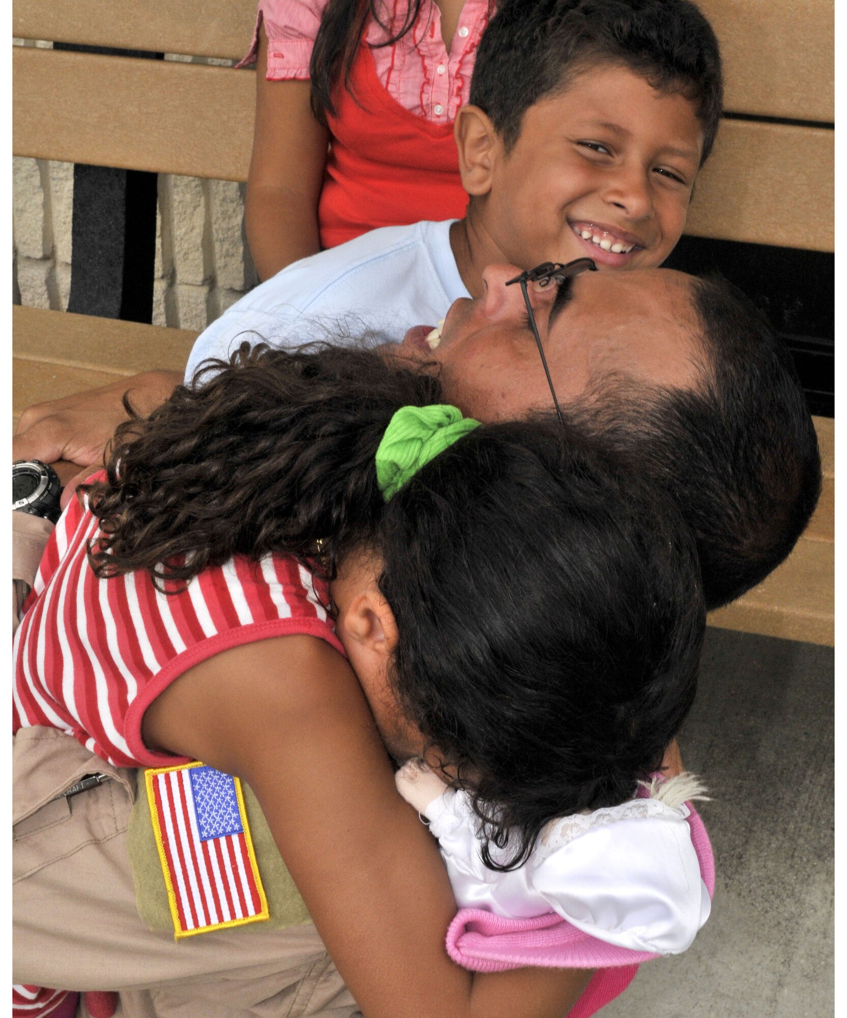 Staff Sgt. Gari Pabon, an HC-130P/N flight engineer, hugs his son Gabriel and daughter Ivelisse before leaving Patrick Air Force Base, Fla., Aug. 25, 2010. Patrick's 920th Rescue Wing deployed two HC-130P/N Hercules aircraft and 60 reservists to the Horn of Africa for two months.  (U.S. Air Force photo/Staff Sgt. Stephen Collier)