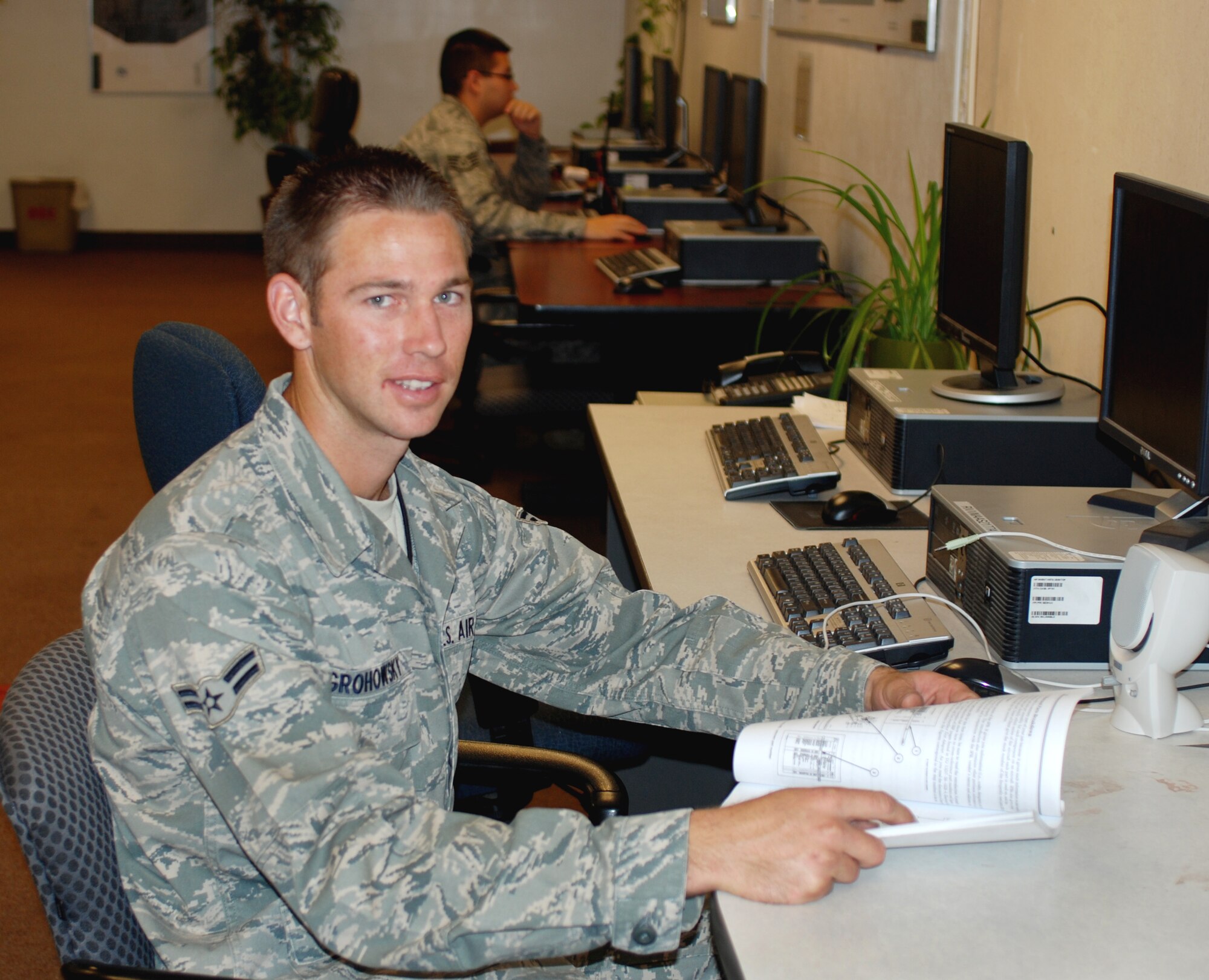 Airman First Class Gabriel Grohowsky studies a career development course book at the 452nd Aircraft Maintenance Squadron building at March Air Reserve Base, Calif., August 23, 2010.  Airman Grohowsky was among the first responders in an off-road racing accident near Lucerne Valley, Calif., that killed eight people Aug. 14.   (U.S. Air Force photo/Megan Just)