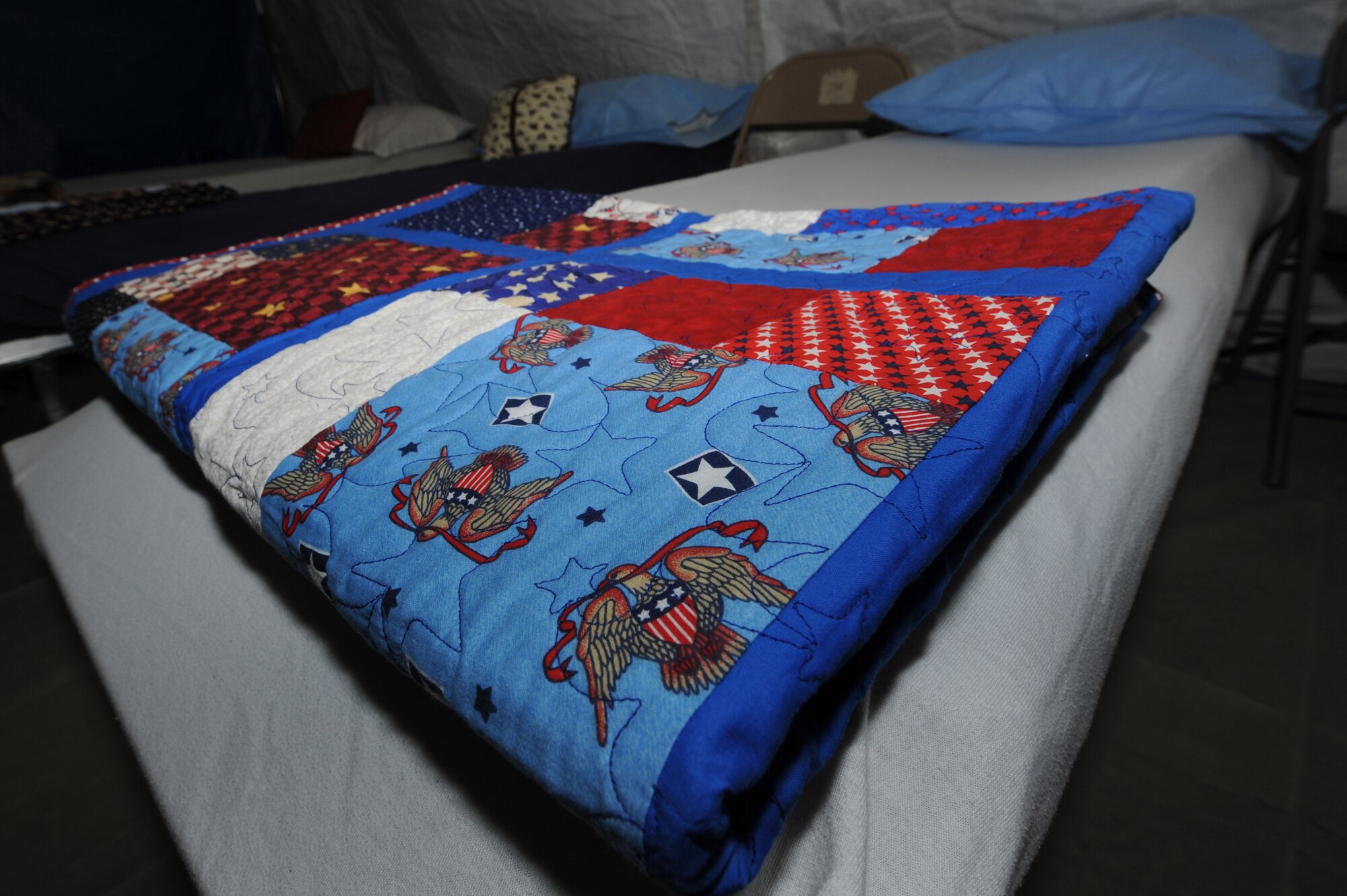 A Quilt of Valor rests on a hospital bed ready to be presented to an injured military servicemember on Aug. 23, 2010, at the 451st Air Expeditionary Wing Contingency Aeromedical Staging Facility, Kandahar Airfield, Afghanistan.  The national Quilts of Valor Foundation has awarded more than 31,000 quilts to wounded warriors since 2003. (U.S. Air Force photo by Tech. Sgt Chad Chisholm/Released)