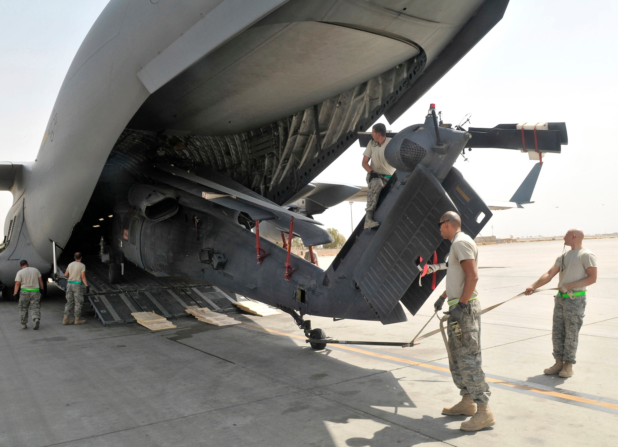 Airmen of the 332nd Expeditionary Aircraft Maintenance Squadron off-load a HH-60 Pave Hawk from a C-17 Globemaster III cargo aircraft Aug. 12, 2010, at Joint Base Balad, Iraq.  (U.S. Air Force photo/Staff Sgt. Phillip Butterfield)
