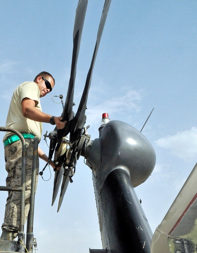 Senior Airman Ronald Hastings unfolds the tail rotor of a HH-60 Pave Hawk helicopter at Joint Base Balad, Iraq, after they received it from a unit in Afghanistan Aug. 12, 2010. Airman Hastings, a native of Pittsburgh, Pa., is deployed with the 332nd Expeditionary Aircraft Maintenance Squadron.   (U.S. Air Force photo/Staff Sgt. Phillip Butterfield)
