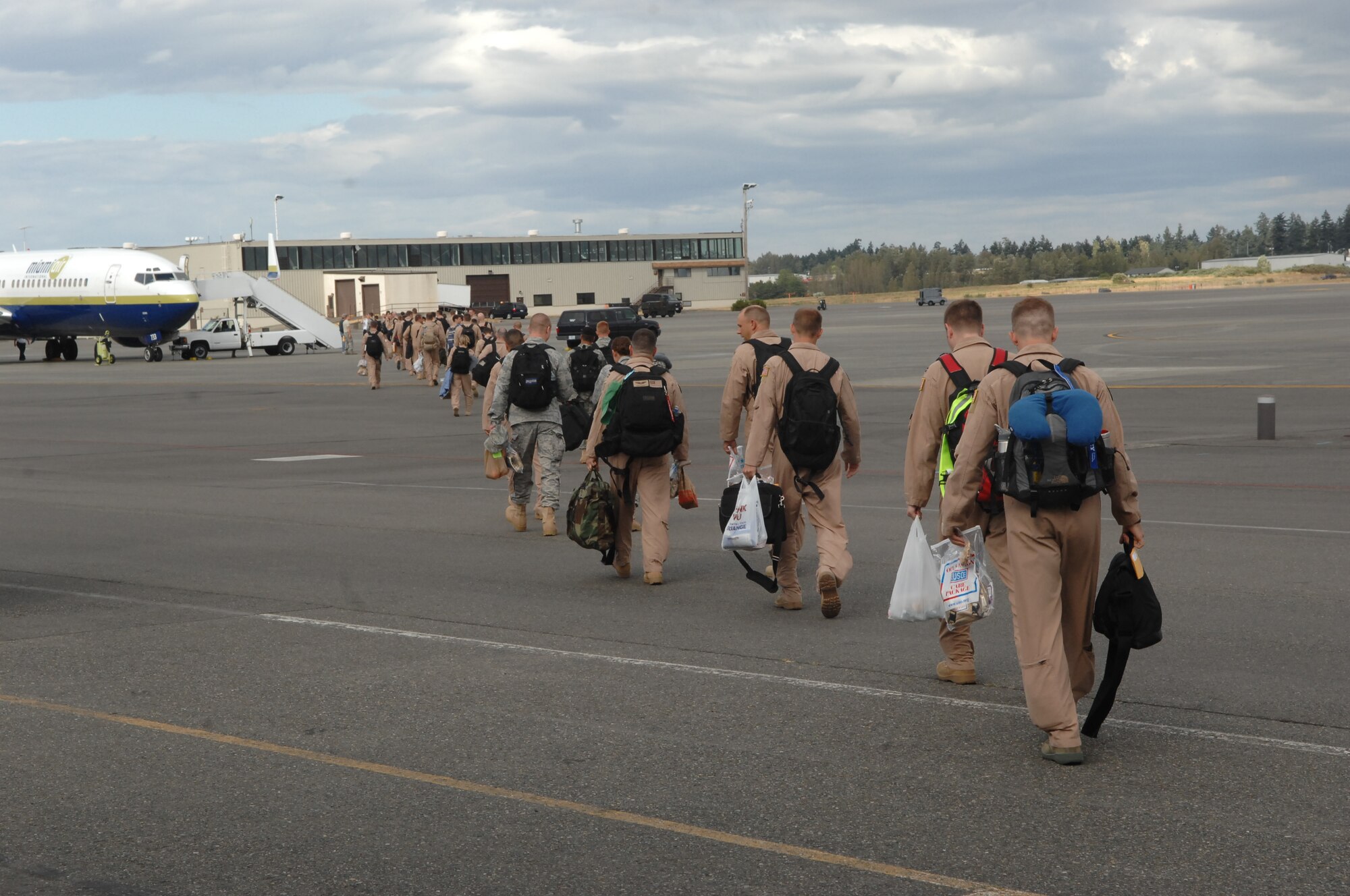 Airmen from the 4th Airlift Squadron board a plane in preparation for their four-month deployment Aug. 26 at Joint Base Lewis-McChord, Wash. The 4th AS will focus on a mission which includes strategic airlift, airdrop, aeromedical evacuation and humanitarian relief. (U.S. Air Force Photo/Airman Leah Young)