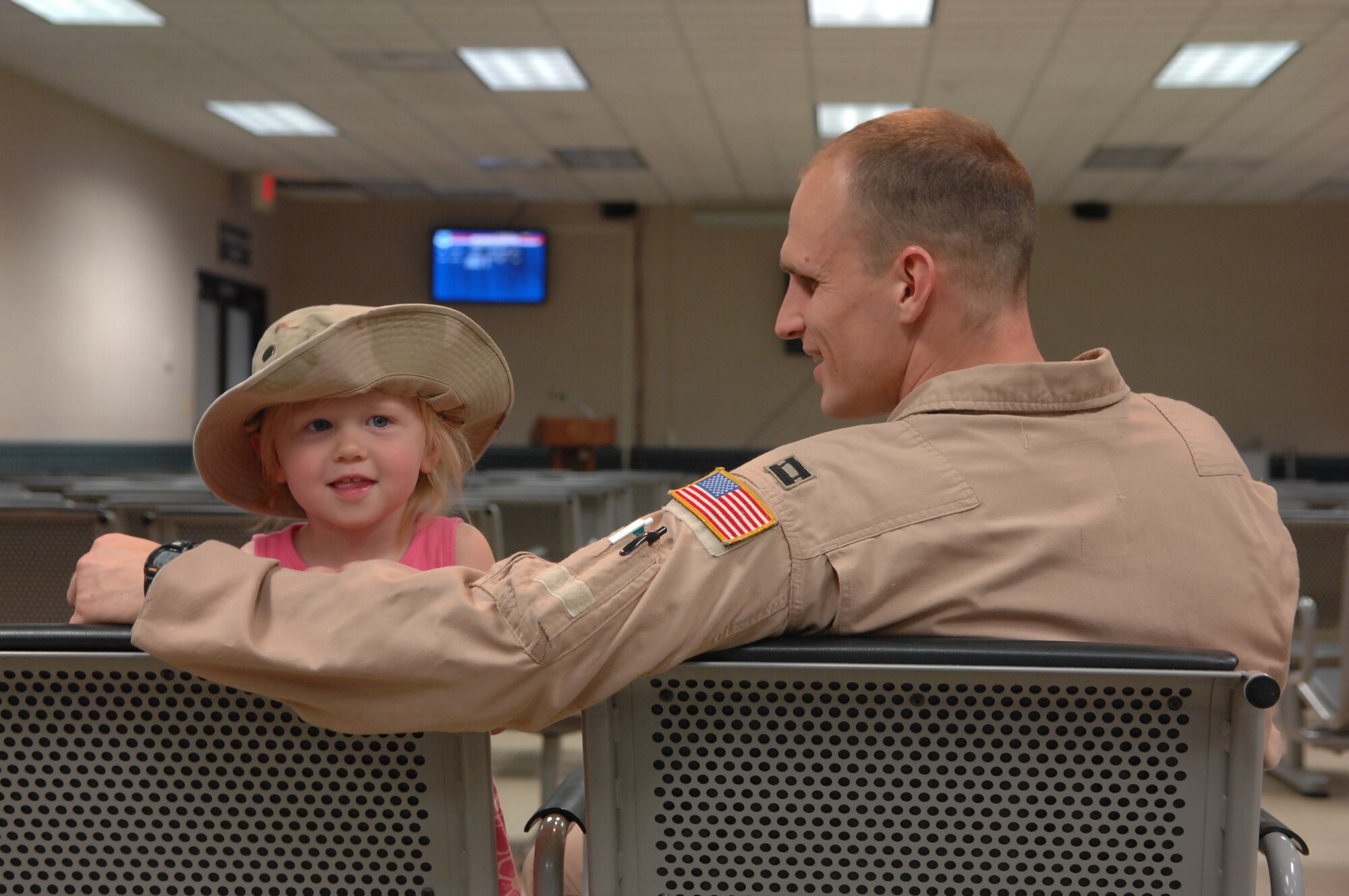 An Airman assigned to the 4th Airlift Squadron spends time with his daughter while waiting to leave for a four month deployment Aug. 26 at Joint Base Lewis-McChord, Wash. (U.S. Air Force Photo/Airman Leah Young)