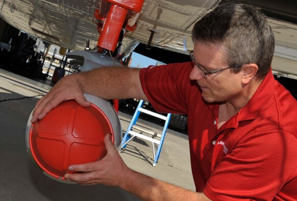 HOLLOMAN AIR FORCE BASE, N.M. -- Eric Peterson secures a protective dome cover on an inert Laser Maverick, Aug. 25, 2010. The Laser Maverick is an air-to-ground missile that can seek out laser-designated targets and this is the first time the 586th Flight Test Squadron has tested external stores on the modified C-12J. Mr. Peterson is the Laser Maverick lead engineer with Raytheon Company. (U.S. Air Force photo/Airman 1st Class Joshua Turner)