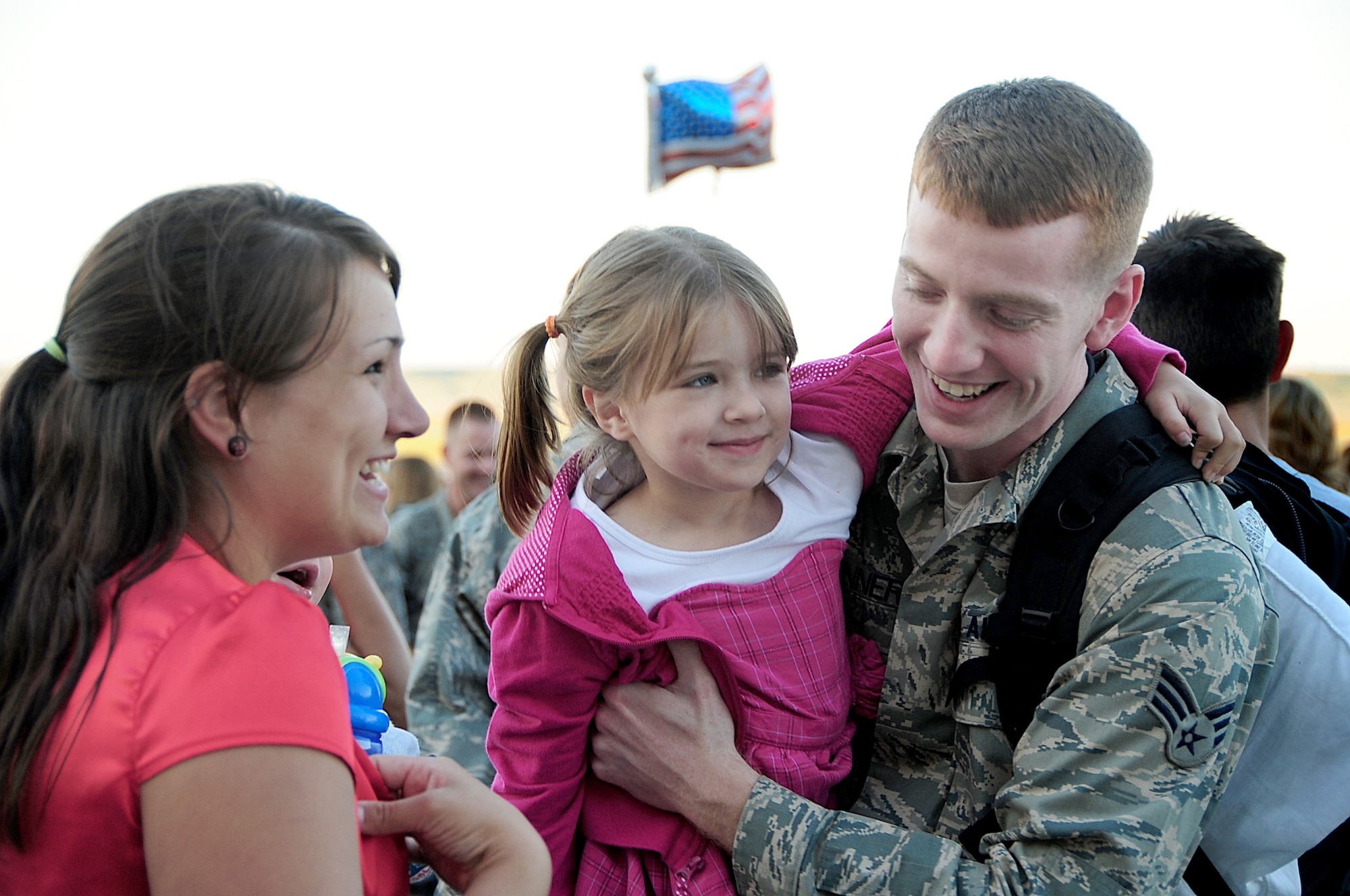 Senior Airman David Benner is reunited with his wife, Kristy, and his daughter, Josie, July 28, 2010, at Ellsworth Air Force Base, S.D., after a deployment to Southwest Asia. More than 190 Airmen were greeted by friends, family and co-workers. Airman Benner is a conventional munitions maintainer assigned to the 28th Munitions Squadron. (U.S. Air Force photo/Airman 1st Class Anthony Sanchelli)