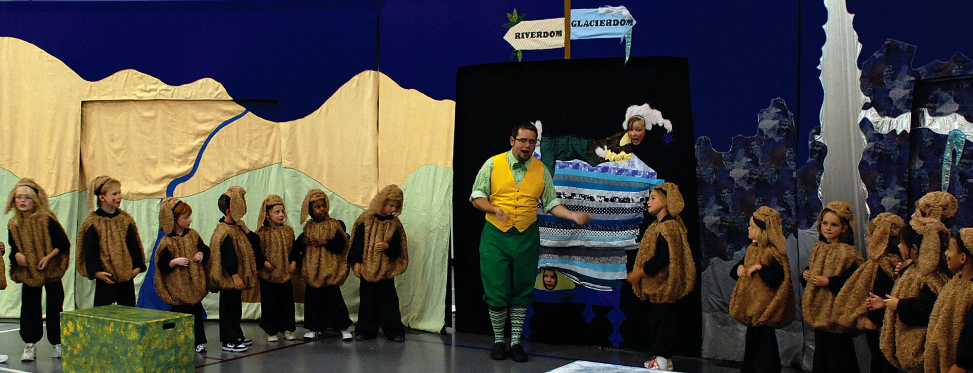 Jeffrey Staso, the play’s director and Head of the Leprechauns, along with several of Warren’s Youth Center children acting as Dust Bunnies, sing the song “Peas and Thank you” to the Princess and the Pea during the final dress rehearsal for “The Princess and the Pea” on Aug. 20 in Warren’s Youth Center. The final performance was later Friday evening. (U.S. Air Force photo by Staff Sgt. Mike Tryon)