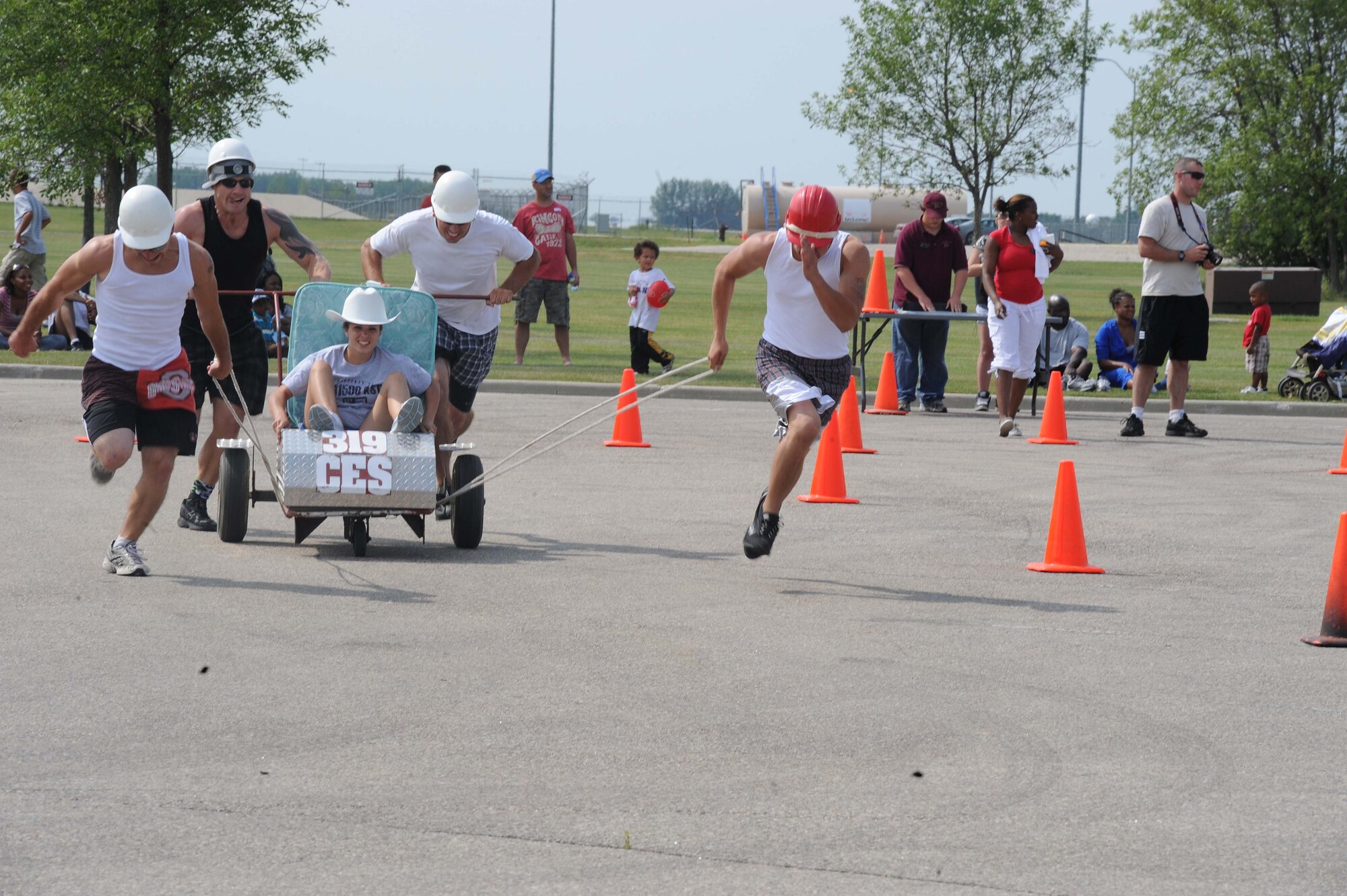 Members of the 319th Civil Engineer Squadron run toward the finish line of the bed race competition Aug. 19 during the Grand Forks Air Force Base Summer Bash.  (U.S. Air Force photo by Airman 1st Class Amber E. Price)