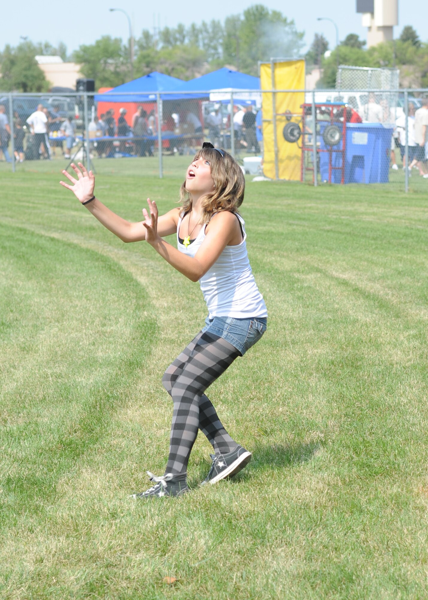 Alex Sasser, daughter of Staff Sgt. James Sasser, 319th Aircraft Maintenance Squadron, focuses on catching an egg Aug. 19 during the Grand Forks Air Force Base Summer Bash. Alex and her sister, Angela Sasser, won first place in the family egg toss competition. (U.S. Air Force photo by Staff Sgt. Suellyn F. Nuckolls)