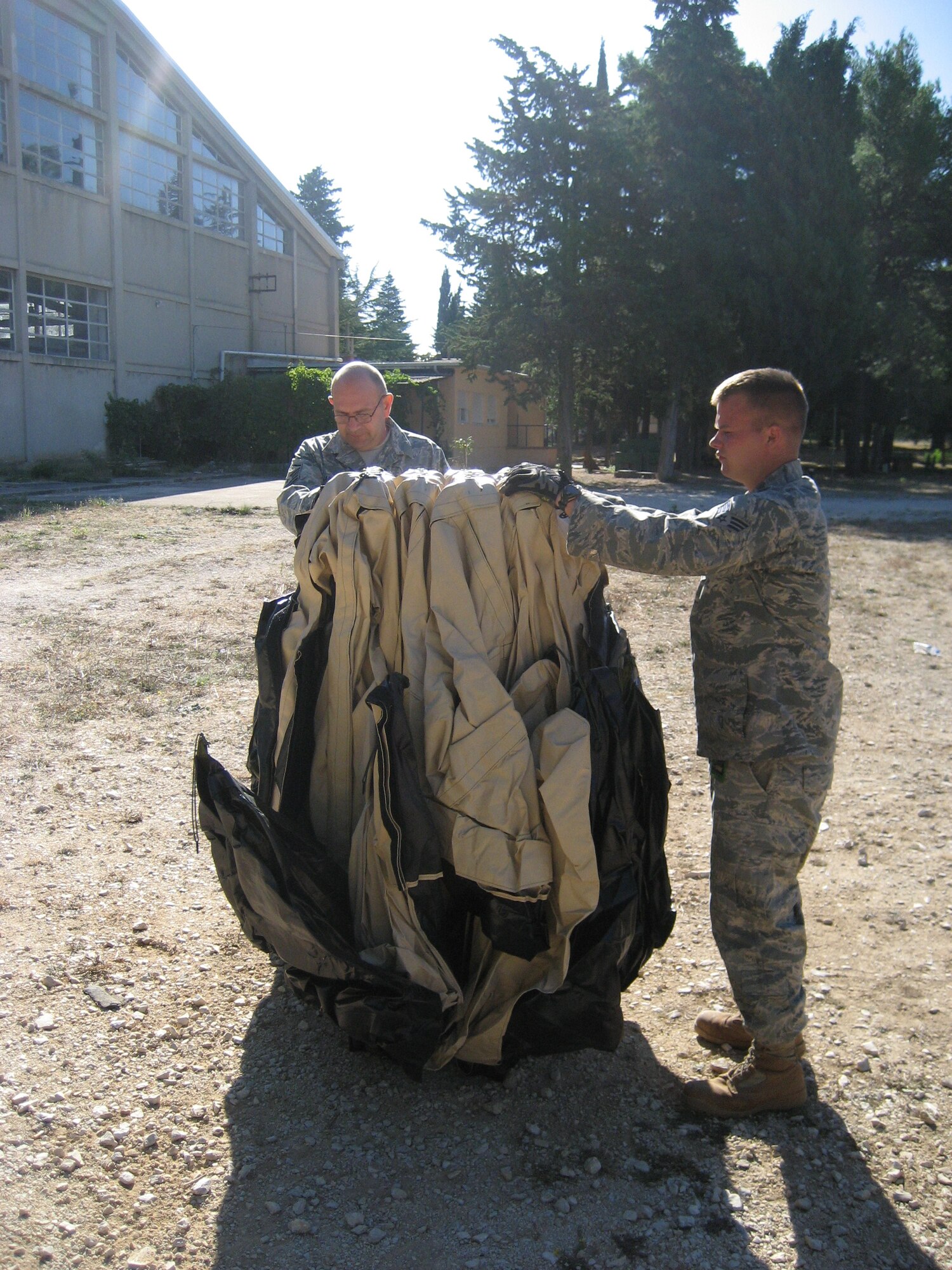 Master Sgt. James Jarvis, left, and Senior Airman Ben Rasine, right, both 1st Special Operations Civil Engineer Squadron J-Team, open a tent segment of an air rapid response kit during Operation Jackal Stone in Croatia, September 2009. The J-Team is comprised of engineering specialists who enable special operations forces by providing resources to sustain their presence for weeks wherever they are required. (Courtesy photo from U.S. Air Force 1st Lt. Jeffrey Buchholtz)