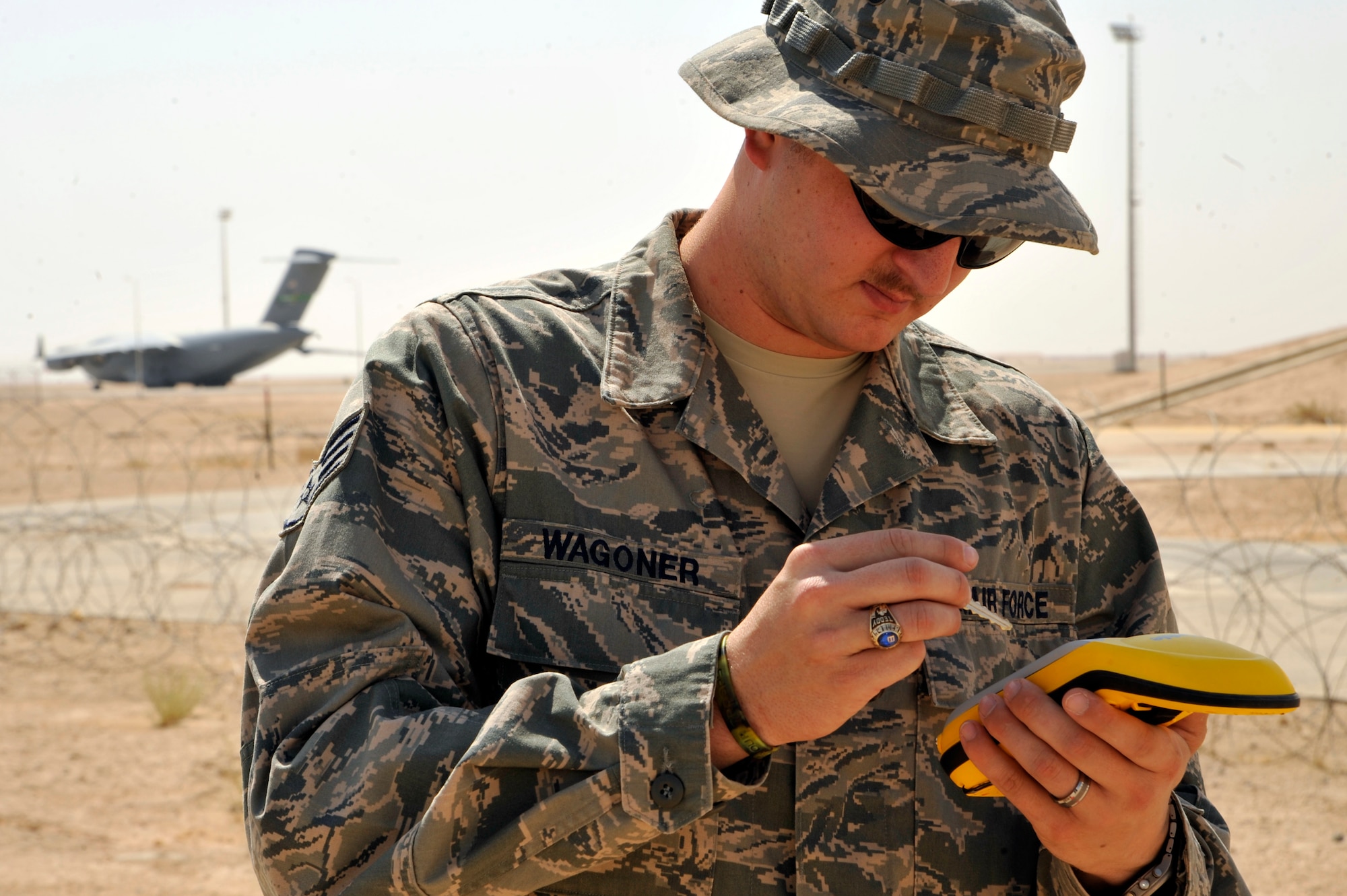 Staff Sgt. Teddy Wagner, 732nd Expeditionary PRIME BEEF Squadron Facility Engineer Team engineer assistant, plots the location of power lines on a GPS device Aug. 17, 2010 at Al Asad Air Base, Iraq. Sergeant Wagner will use the GPS coordinates to draw the location of the lines on a map. When Al Asad AB is returned to the Iraqis, they will have a detailed map available to them. ( U.S. Air Force photo by Senior Airman Perry Aston) (Released)