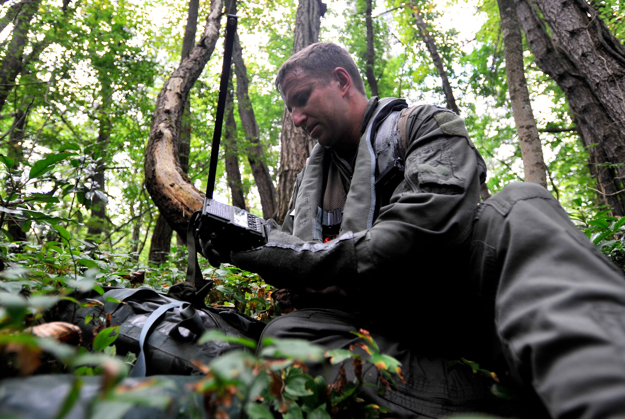 MISAWA AIR BASE, Japan -- Capt. Don Davenport,  13th Fighter Squadron F-16 pilot, calls in for help during combat survival training Aug. 26. The training keeps pilots proficient and current in survival skills. (U.S. Air Force photo/Staff Sgt. Chad C. Strohmeyer)