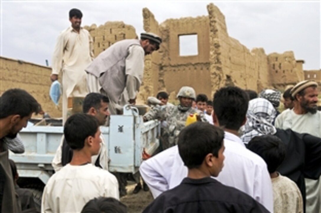 U.S. Army Capt. Terrance McIntosh distributes much needed supplies during a humanitarian mission to the village of Bashikal in Afghanistan's Parwan province, Aug. 25, 2010. Floods recently damaged the village as residents observed the holy month of Ramadan. The supplies, which included included rice and cooking oil, provided a boost in morale for the villagers. McIntosh is a civil affairs officer assigned to Headquarters Troop, 1st Squadron, 172nd Cavalry Regiment.