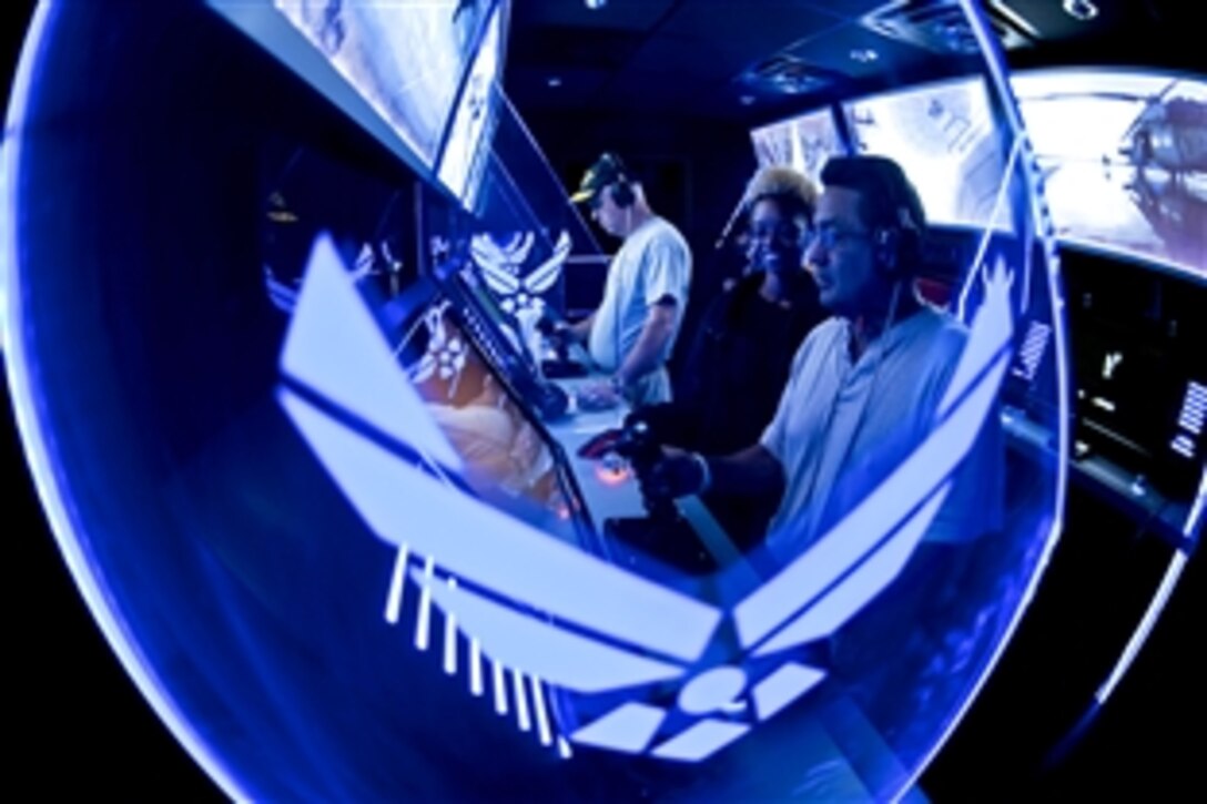 Kim Goodin, left, and Frank Bazan, right, try their best to be good operators in the Stealth Tour interactive display in Times Square during Air Force Week New York City, Aug. 26, 2010.