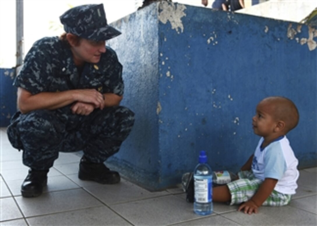 U.S. Navy Lt. Traci Burrell talks to a Costa Rican boy at a medical site in Limon, Costa Rica, during Continuing Promise on Aug. 22, 2010.  Service members and civilians were deployed in support of Continuing Promise to provide humanitarian assistance and disaster relief in the Caribbean, Central America and South America.  