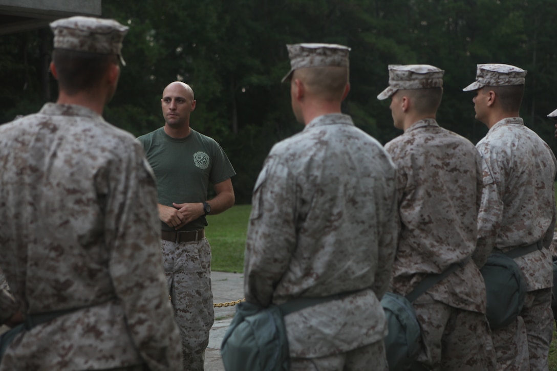 Staff Sergeant Gary Beals, facing, a chemical, biological, radiological and nuclear defense instructor with the 22nd Marine Expeditionary Unit and Metaric, La., native, briefs the unit's Marines before they enter a gas chamber with new M-50 field protective masks aboard Camp Lejeune, N.C., Aug. 27, 2010. The MEU was the first unit in the Marine Corps on the east coast to receive the new M-50 gas-mask. The annual training is designed to instill confidence in the mask and ensure the Marines know the proper wear of the equipment.