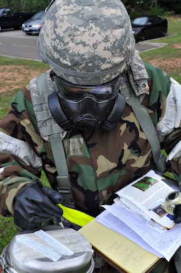U.S. Air Force Airman 1st Class Hunter Wingo, 86th Security Forces Squadron, checks M-8 Chemical Agent Detector Paper during an operational readiness exercise, Ramstein Air Base, Germany, Aug. 28, 2010. An ORE incorporates a series of scenarios to evaluate a base's ability to execute operational duties under simulated wartime conditions. (U.S. Air Force photo by Airman 1st Class Desiree Esposito)