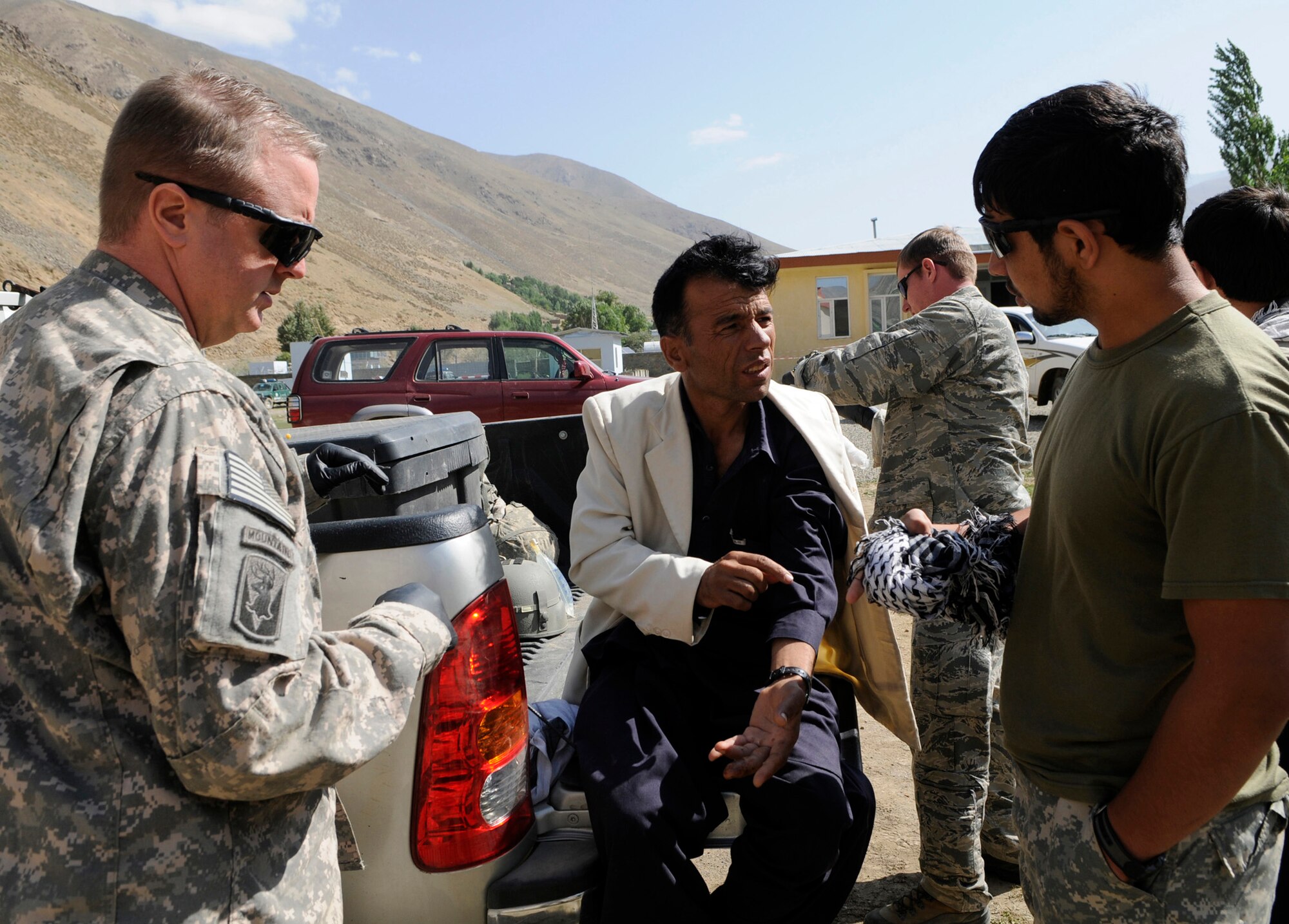 During a stop at the Khenj Afghan National Police station a local man approached member of Provincial Reconstruction Team Panjshir for medical assistance.  U.S. Air Force Captain Michael Calnicean, Forward Operating Base Lion chief medical officer from Detroit Mi., examined the gentleman and identified several infected cuts caused by a skin infection of his left hand.  (U.S. Air Force photo by: Tech. Sgt. Sean Mateo White, PRT Panjshir photographer)