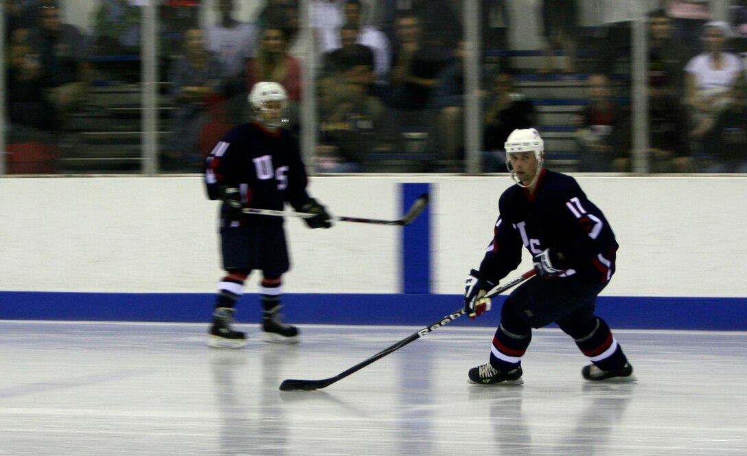 Jeremy Gabbard, forward for the Navy, Marine, Coast Guard team, blazes across the ice during the first-ever Wounded Warriors Charity Hockey Game Aug. 29 at the Ice Palace, Aiea, Hawaii. The Army, Air Force Team took the win 5-3. Garbbard scored the third goal for his team with 26.5 seconds left in the game in a losing effort.