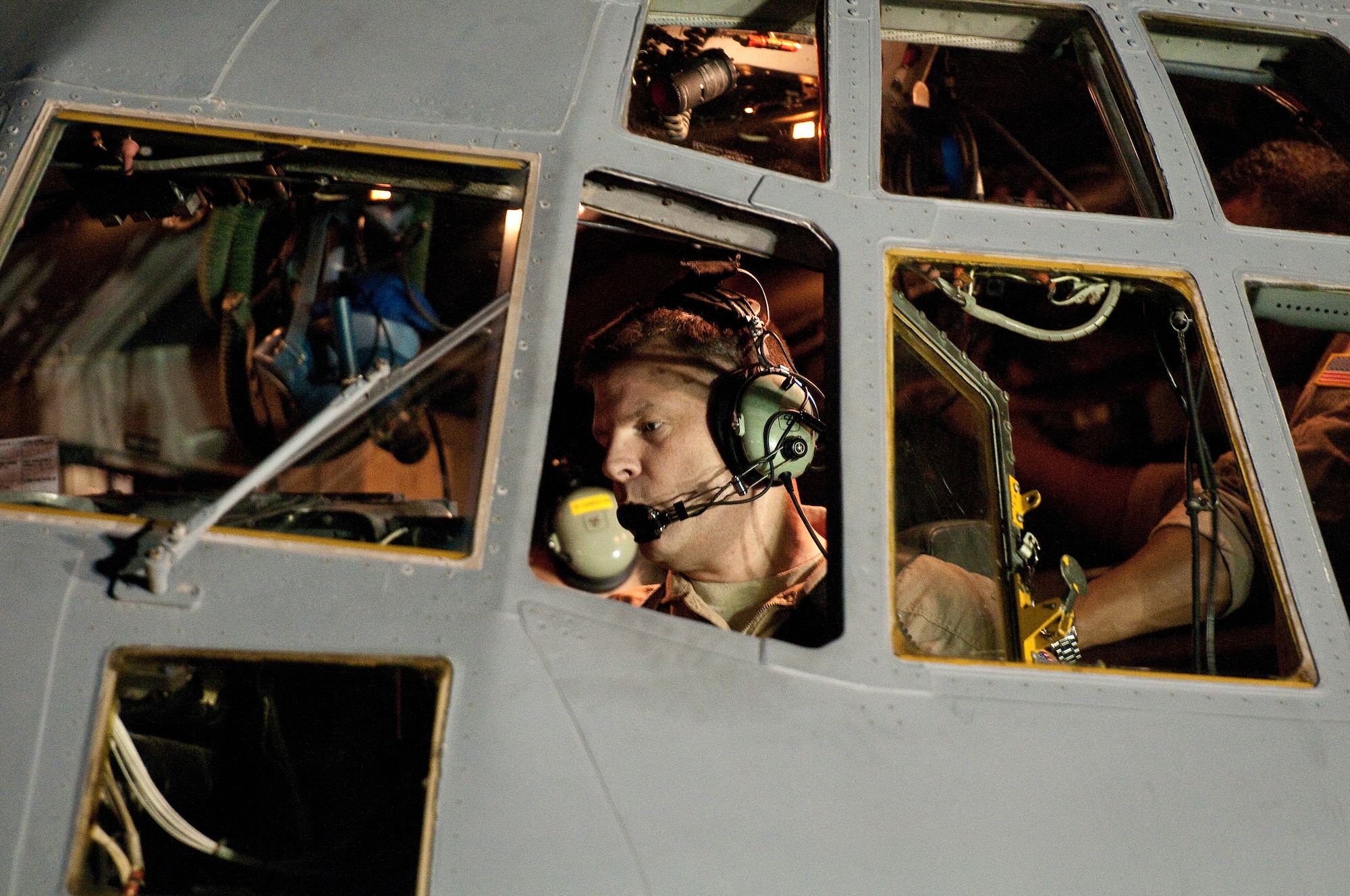 SOUTHWEST ASIA - Col. Scott Brewer, commander of the 386th Expeditionary Operations Group, runs through a pre-flight checklist Aug. 29, 2010 as he prepares to pilot a U.S. Air Force EC-130H aircraft assigned to the 43rd Expeditionary Electronic Combat Sqaudron. The 43rd EECS, which has been part of the 386th Air Expeditionary Wing for 6 1/2 years, is moving to another base in the U.S. Central Command area of responsibility becuase of the responsible drawdown of forces in Iraq. The EC-130H Compass Call aircraft provides U.S. forces with the ability to jam enemy communications. (U.S. Air Force photo by Maj. Dale Greer/Released)