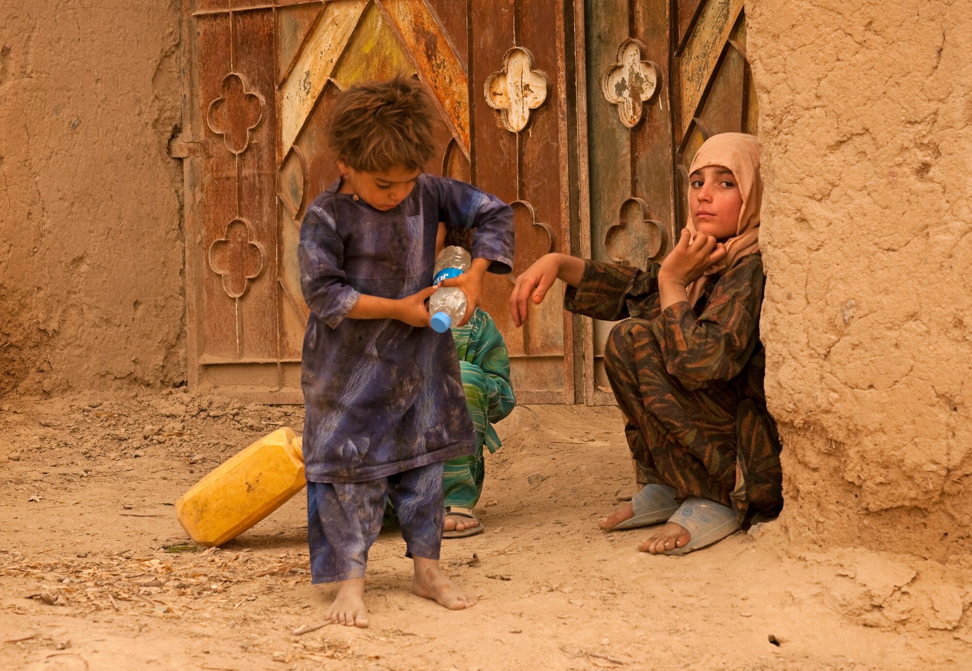 COMBAT OUTPOST MIZAN, Afghanistan - Afghan children play in the streets as a combined dismounted patrol passes their village during a dismounted patrol near Combat Outpost Mizan, Mizan District, Zabul Province, Aug. 26. Members of 3rd Platoon, Fox Company, 2nd Squadron, 2nd Stryker Cavalry Regiment, Provincial Reconstruction Team Zabul and Afghan National Security Forces patrolled the area to meet with local elders and ensure security in the area.  (U.S. Air Force Photo/Senior Airman Nathanael Callon/Released)
