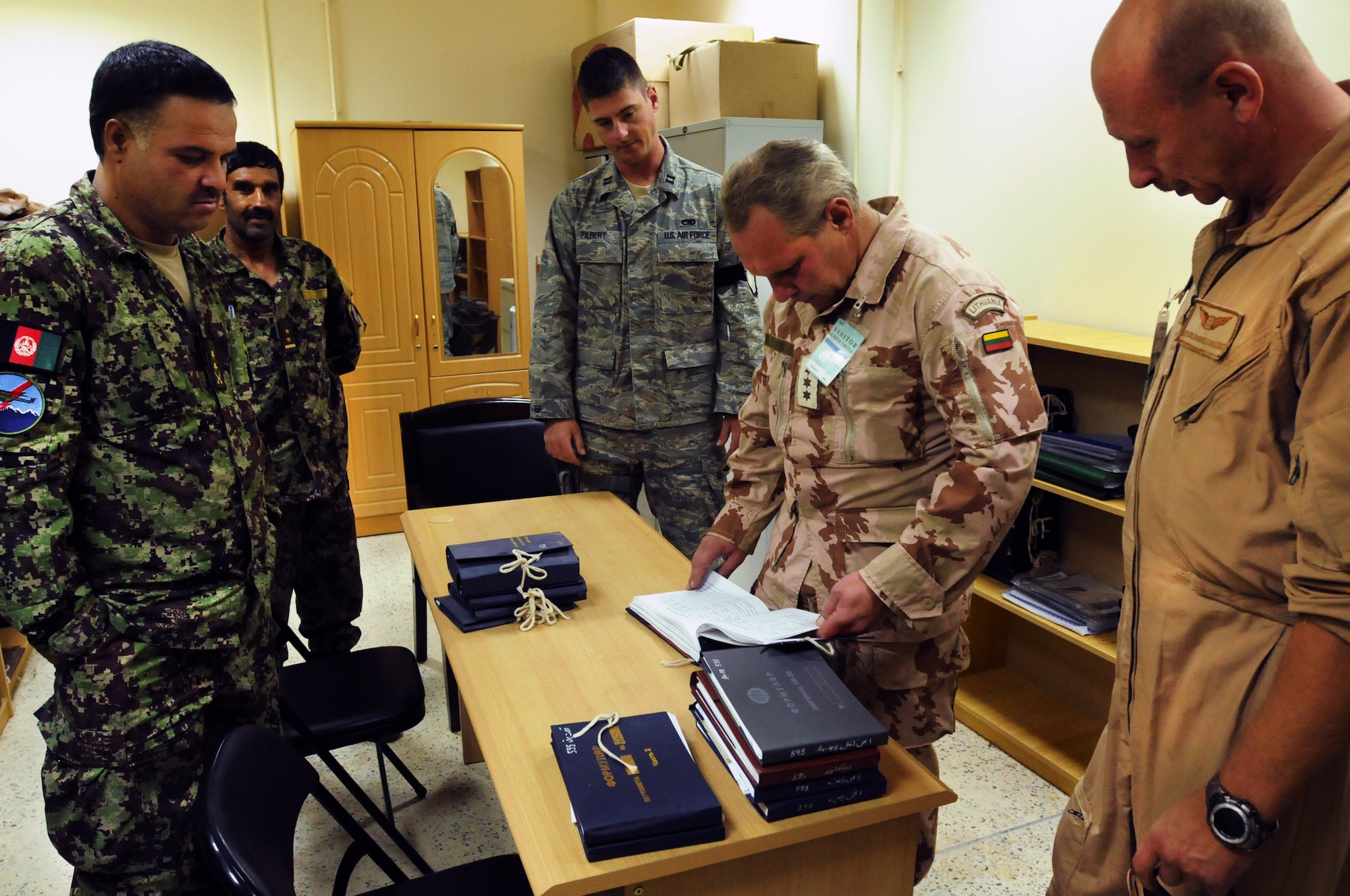 100828-N-6031Q-001 KABUL, Afghanistan -A Lithuanian delegation, right, studies Mi-17 Helicopter maintenance log books as they gather information on Aug. 28, 2010 in preparation for the development of their own advisory team to be stationed in Kandahar. The Lithuanian military has committed to a two year advisory partnership with the Combined Air Power Transition Force with the desire to bring their perspective to the development of the Afghan Air Force. (US Navy photo by Mass Communication Specialist 2nd Class David Quillen/ RELEASED).