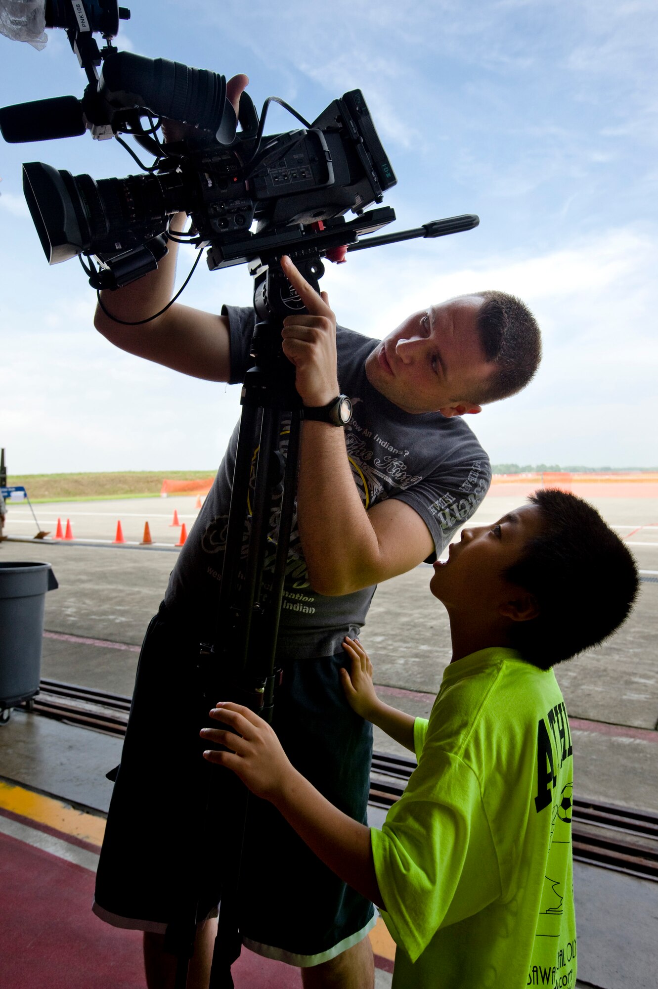 U.S. Air Force Airman Donald Moreland, Armed Forces Network broadcaster, shows some footage to a Special Olympics athlete during the annual Special Olympics at Misawa Air Base, Japan, Aug. 28, 2010. The child had taken an interest in Airman Moreland's video camera, taking a break from the athletic events. (U.S. Air Force photo by Staff Sgt. Samuel Morse/Released)