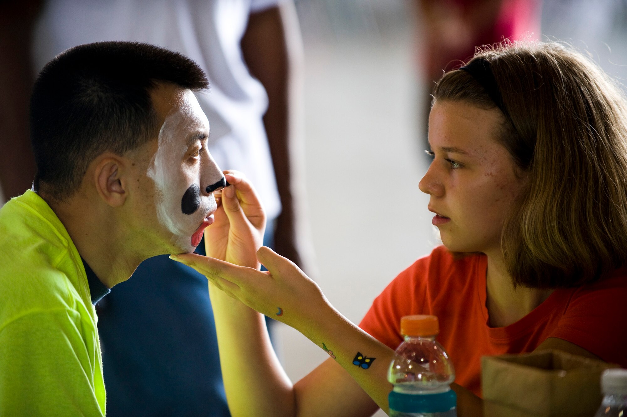 Hannah Thomascall paints a Special Olympics athlete's face during the annual Special Olympics at Misawa Air Base, Japan, Aug. 28, 2010. Approximately 300 volunteers, more than the organizing committee had anticipated, worked to make the day enjoyable for the athletes. (U.S. Air Force photo by Staff Sgt. Samuel Morse/Released)