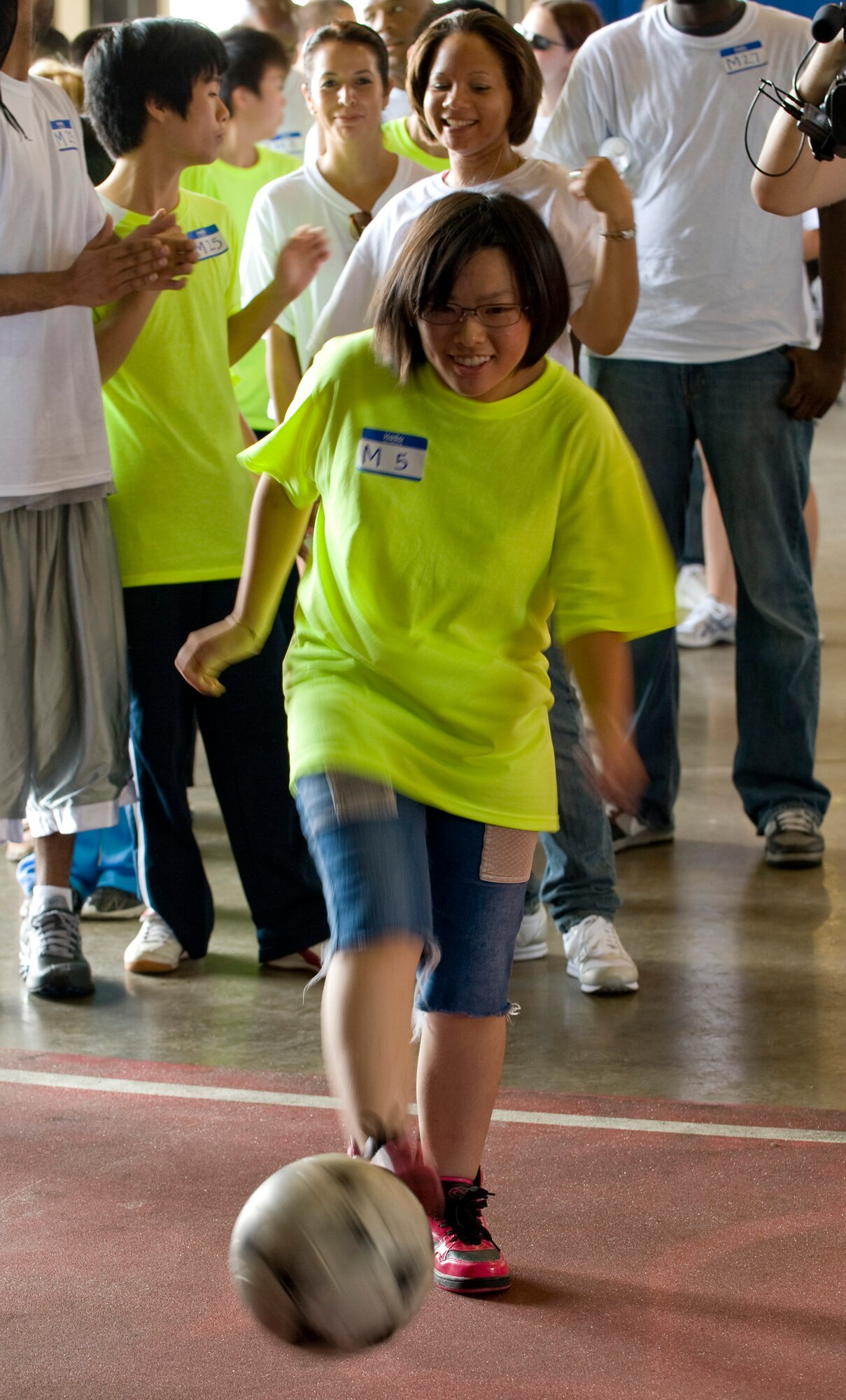 A Special Olympics athlete kicks a soccer ball in Hangar 949 during the annual Special Olympics at Misawa Air Base, Japan, Aug. 28, 2010. Athletes participated in various activities including a 75- and 50-meter dash, bowling, soccer kick and volleyball. (U.S. Air Force photo by Staff Sgt. Samuel Morse/Released)