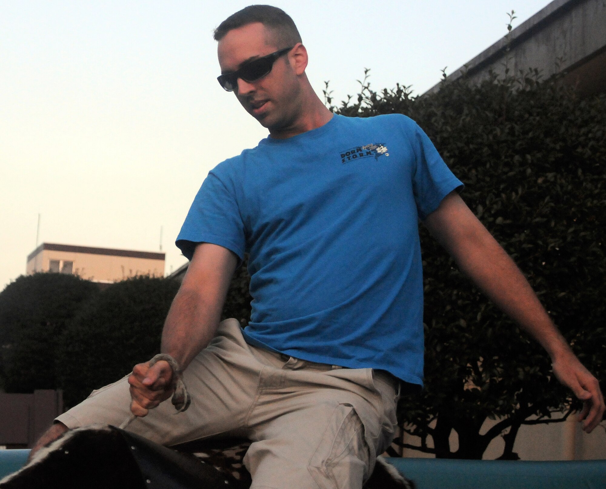 YOKOTA AIR BASE, Japan -- Airman 1st Class David Meade, Armed Forces Network-Tokyo broadcaster, rides a mechanical bull during the Cowboy Customer Appreciation dinner, here August 26. The customer appreciation dinner was held outside the Samurai Cafe. (U.S. Air Force photo/Airman 1st Class Katrina R. Menchaca)