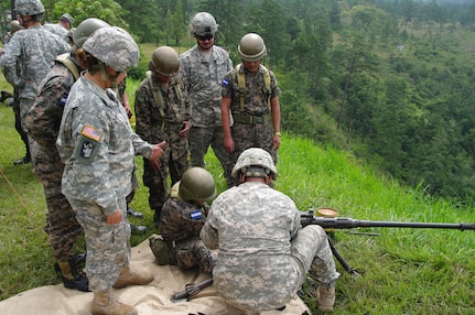 SOTO CANO AIR BASE, Honduras --  Sgt. 1st Class Allen King, Sgt. Delmi Quevedo and Sgt. Jason Myers, all with the 1-228th Aviation Regiment, instruct Honduran soldiers on the proper firing techniques for the M2 at the Zambrano Range here Aug. 25. During the course of training, 1-228th Soldiers provided instruction on the M2 and M249 weapons systems to Honduran soldiers. (Photo courtesy of Capt. Thomas Pierce)