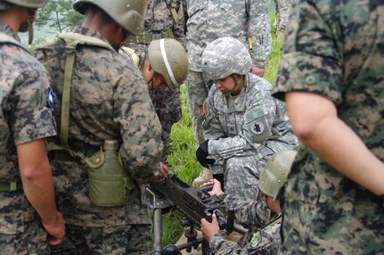SOTO CANO AIR BASE, Honduras --  Sgt. Delmi Quevedo, a Soldier with the 1-228th Aviation Regiment, observes and instructs Honduran soldiers on conducting a preliminary marksmanship instruction on the M2 at the Zambrano Range here Aug. 25. During the course of training, 1-228th Soldiers provided instruction on the M2 and M249 weapons systems to Honduran Soldiers. (Photo courtesy of Capt. Thomas Pierce)