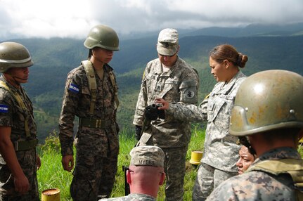 SOTO CANO AIR BASE, Honduras --  Sgt. 1st Class Allen King, Sgt. Delmi Quevedo, Sgt. Jason Myers and Spc. Salvador Nunez, all with the 1-228th Aviation Regiment, instruct Honduran soldiers on assembly and disassembly of the M2 at the Zambrano Range here Aug. 25. Proper assembly, maintenance, preliminary marksmanship instruction and firing techniques were taught by bilingual 1-228th Soldiers providing Honduran soldiers with a basic knowledge of both M2 and M249 weapons systems. (Photo courtesy of Capt. Thomas Pierce)
