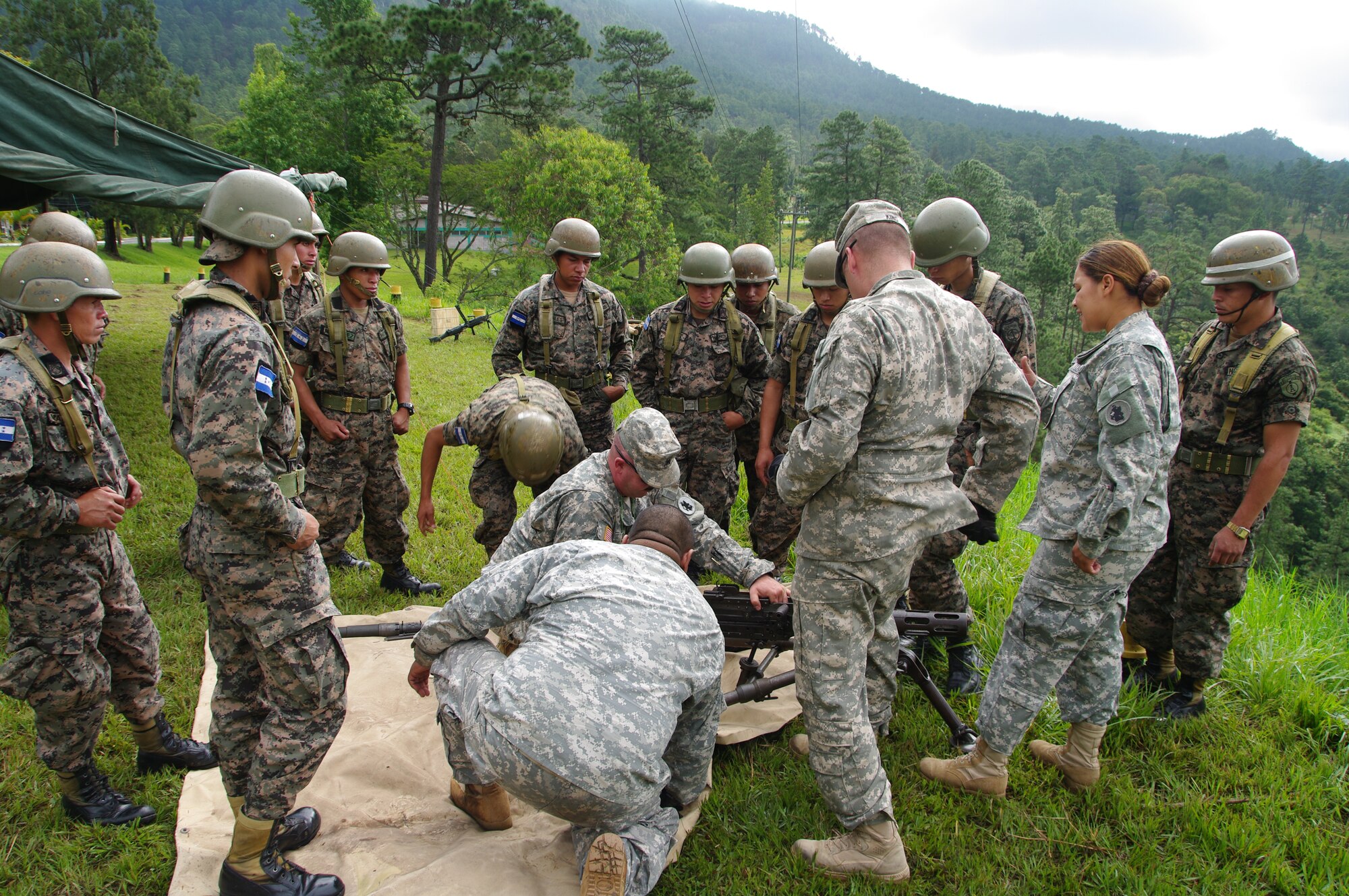 SOTO CANO AIR BASE, Honduras --  Sgt. 1st Class Allen King, Sgt. Delmi Quevedo, Sgt. Jason Myers and Spc. Salvador Nunez, all with the 1-228th Aviation Regiment, instruct Honduran soldiers on assembly and disassembly of the M2 at the Zambrano Range here Aug. 25. During the course of training, 1-228th Soldiers were able to provide instruction on the M2 and M249 weapons systems. (Photo courtesy of Capt. Thomas Pierce)