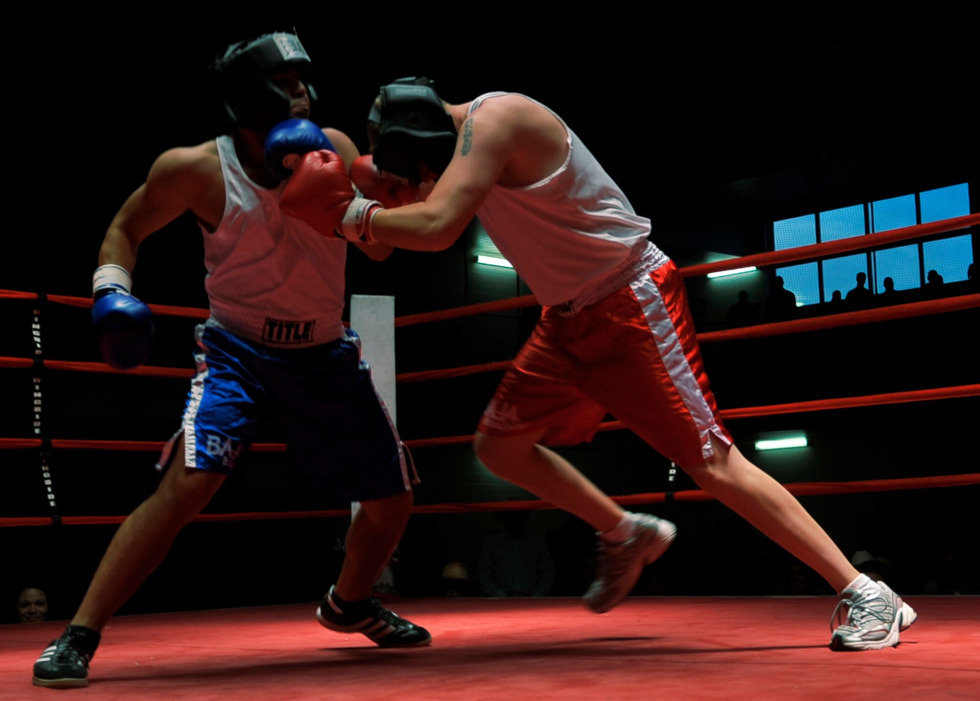 HOLLOMAN AIR FORCE BASE, N.M. -- Albert Dominguez (blue shorts), 49th Force Support Squadron, prepares to uppercut John Buckley (red shorts), 49th Civil Engineer Squadron, during the fifth Raptor Rumble at the Domenici Fitness and Sports Center Aug. 27, 2010. The referee stopped the fight giving Dominguez the victory over Buckley. (U.S. Air Force photo by Airman 1st Class Joshua Turner / Released)