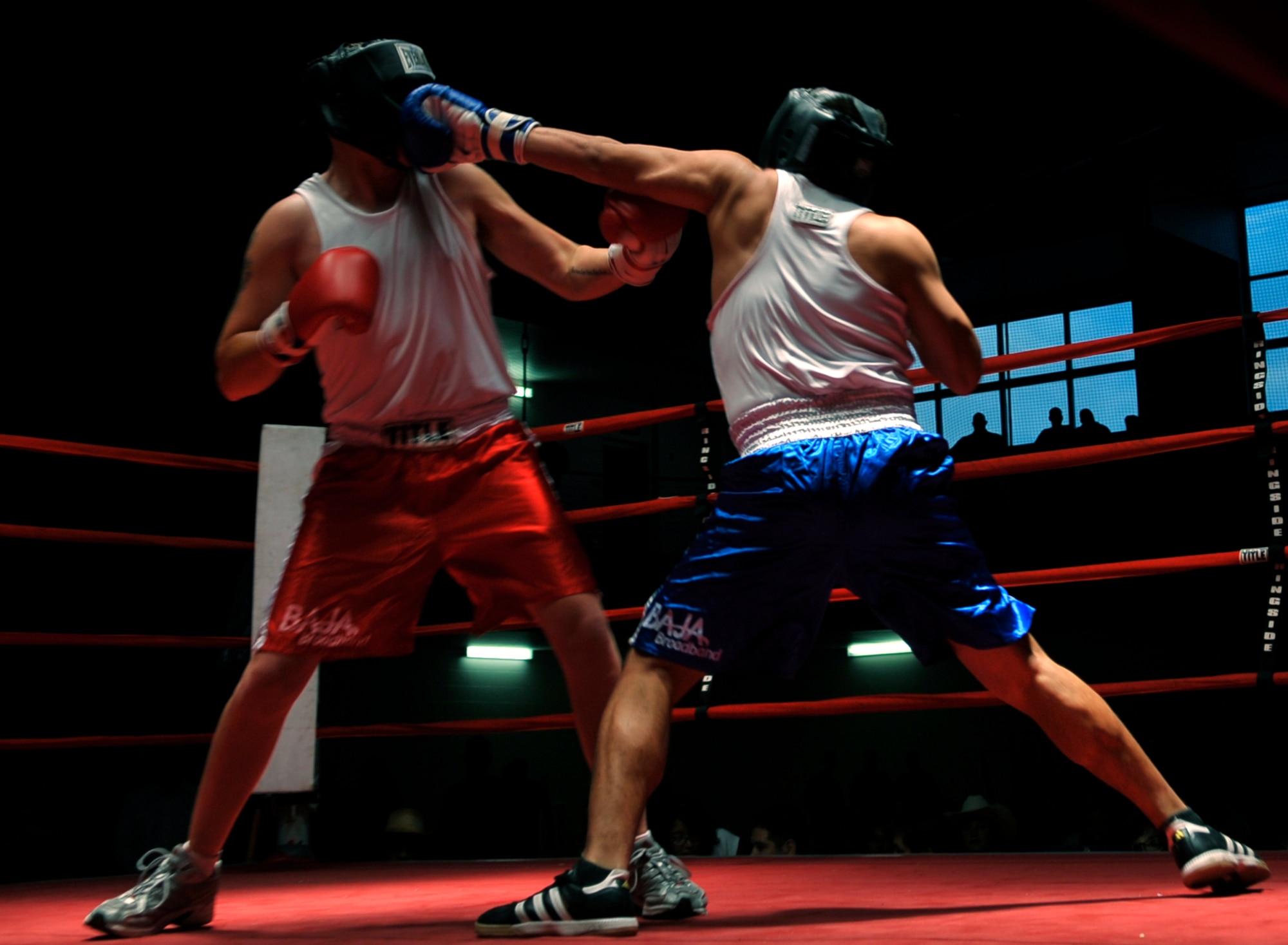 HOLLOMAN AIR FORCE BASE, N.M. -- Albert Dominguez (blue shorts), 49th Force Support Squadron lands a jab on John Buckley(red shorts), 49th Civil Engineer Squadron, during the fifth Raptor Rumble at the Domenici Fitness and Sports Center Aug. 27, 2010. The referee stopped the fight giving Dominguez the victory over Buckley. (U.S. Air Force photo by Airman 1st Class Joshua Turner / Released)