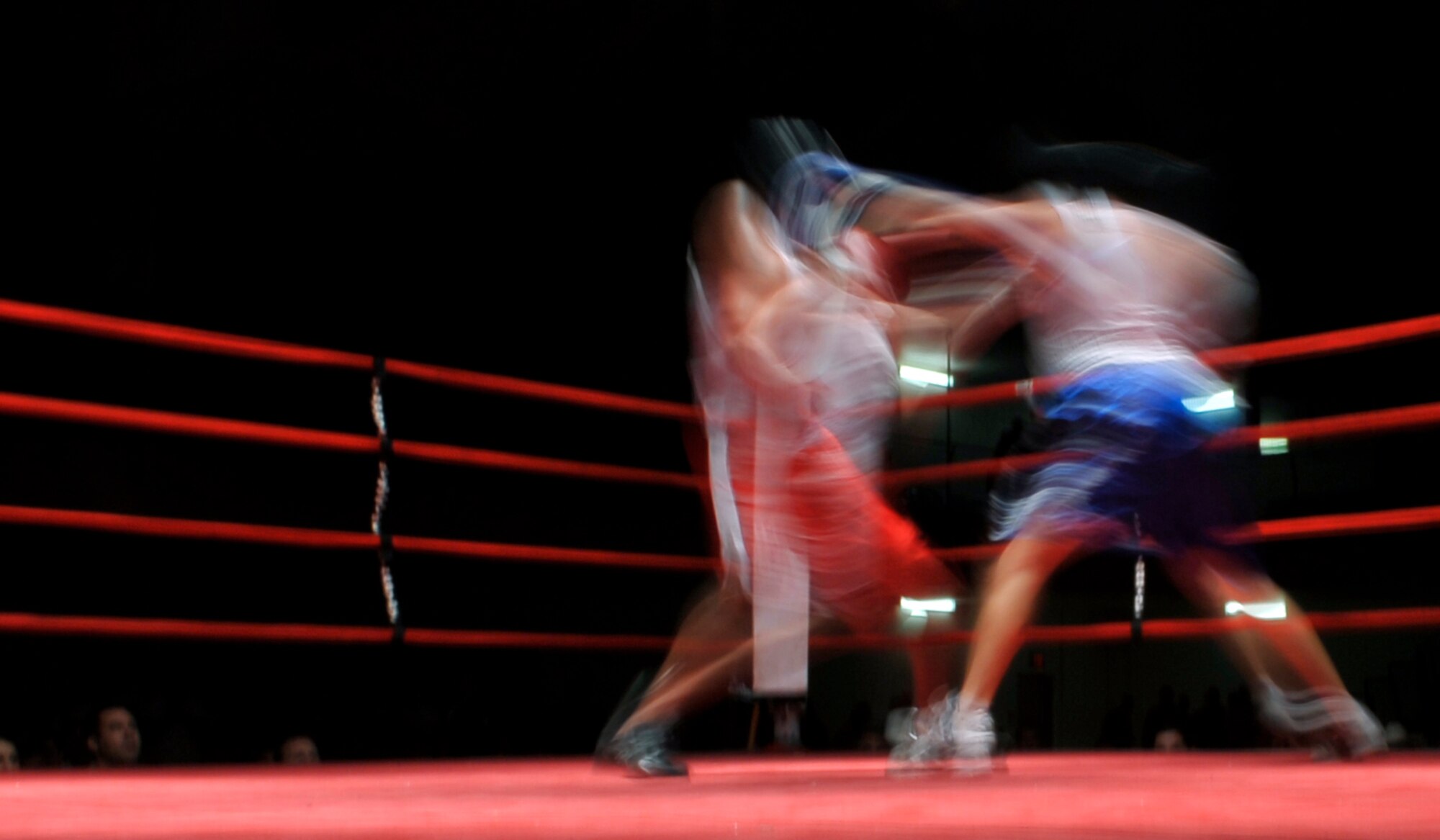 HOLLOMAN AIR FORCE BASE, N.M. -- David Gonzalez (blue shorts), 49th Maintenance Squadron, and Brett Hendrickson (red shorts), 49th Civil Engineer Squadron, box during the fifth Raptor Rumble at the Domenici Fitness and Sports Center Aug. 27, 2010. The referee stopped the fight giving Hendrickson th victory over Gonzalez. (U.S. Air Force photo by Airman 1st Class Joshua Turner / Released)