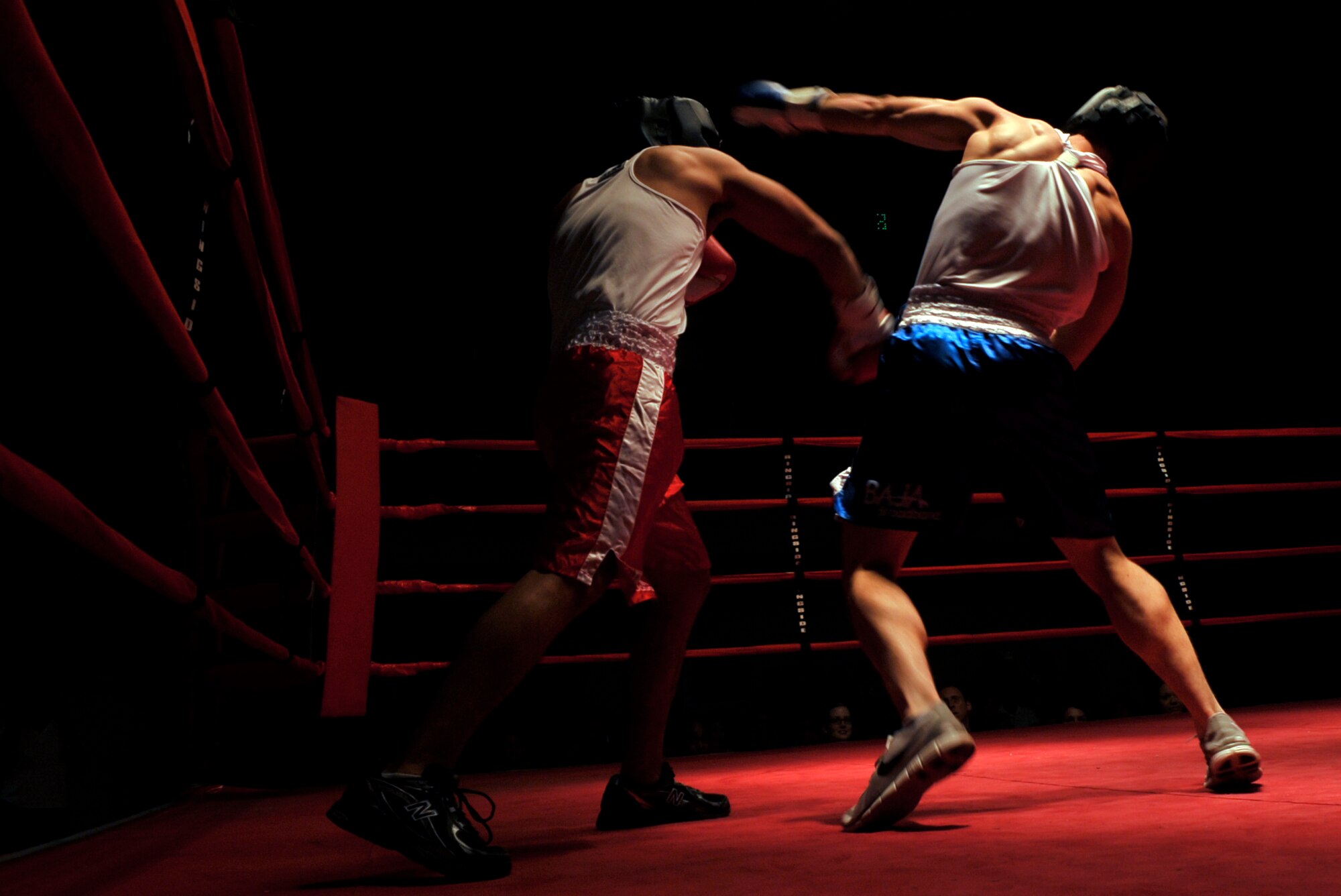 HOLLOMAN AIR FORCE BASE, N.M. -- Emmanuel Rodriguez (red shorts), 49th Medical Support Squadron, throws a right hook at Christopher Carey (blue shorts), 49th Civil Engineer Squadron, during the fifth Raptor Rumble at the Domenici Fitness and Sports Center Aug. 27, 2010. The referee stopped the fight giving Rodriguez the victory over Carey. (U.S. Air Force photo by Airman 1st Class Joshua Turner / Released)