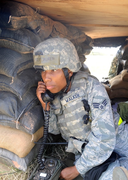 DYESS AIR FORCE BASE, Texas—Senior Airman Lauren Walker, 7th Expeditionary Security Forces Squadron, simulates calling the law enforcement desk during a Phase II Operational Readiness Exercise Aug. 30 here. Operational Readiness Exercises occur every couple of months to ensure Airmen are mission ready. (U.S. Air Force photo/ Senior Airman Felicia Juenke)               