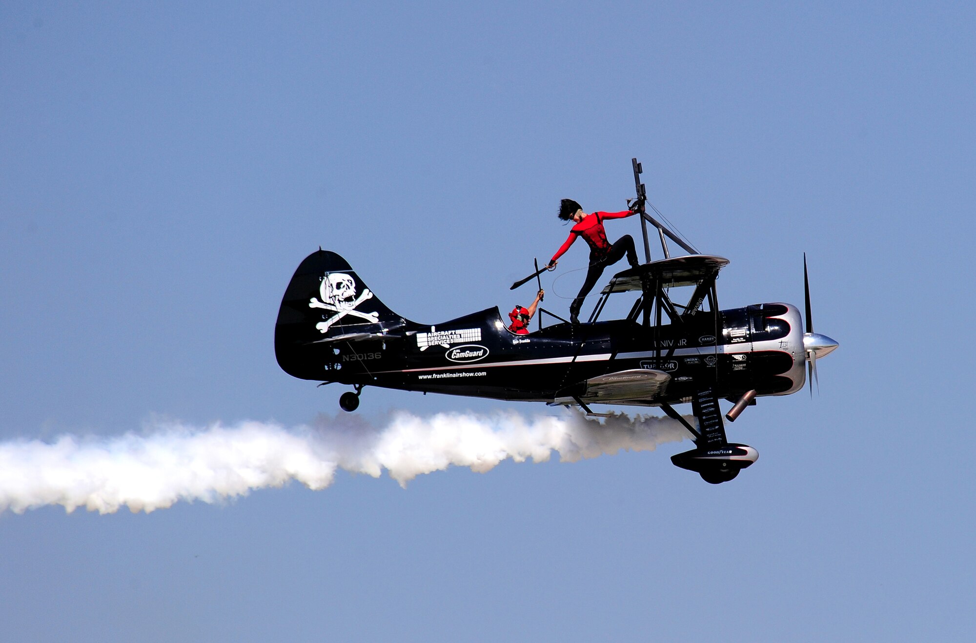 OFFUTT AIR FORCE BASE, Neb. - The Pirated Skies wing walking team of Kyle and Amanda Franklin took to the air Aug. 28 as part of the 2010 Defenders of Freedom Open House and Airshow to give the audience a daredevil performance with a pirate twist. This was the first time the Pirated Skies performance was at Offutt's annual air show. The show included this and other aerial performances as well as ground shows and static aircraft displays. U.S. Air Force photo by Josh Plueger
