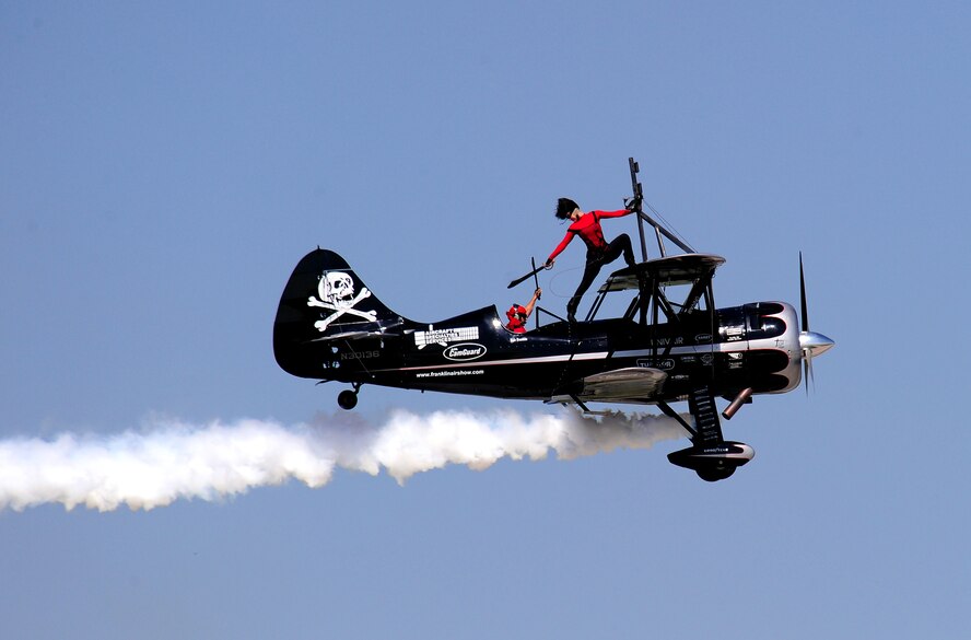 OFFUTT AIR FORCE BASE, Neb. - The Pirated Skies wing walking team of Kyle and Amanda Franklin took to the air Aug. 28 as part of the 2010 Defenders of Freedom Open House and Airshow to give the audience a daredevil performance with a pirate twist. This was the first time the Pirated Skies performance was at Offutt's annual air show. The show included this and other aerial performances as well as ground shows and static aircraft displays. U.S. Air Force photo by Josh Plueger
