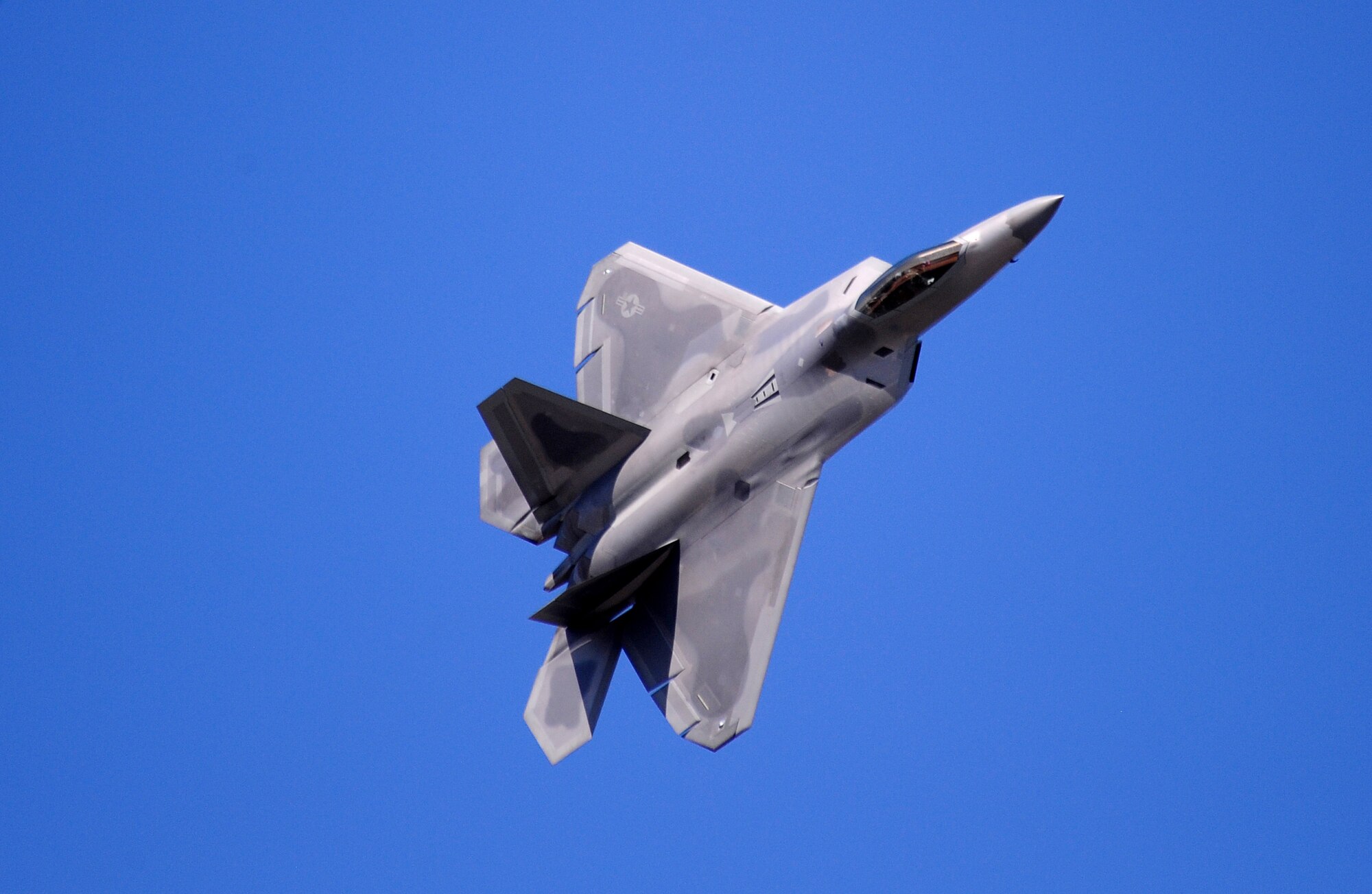 OFFUTT AIR FORCE BASE, Neb. - An F-22 Raptor glides across the sky as part of the 2010 Defenders of Freedom Open House and Air Show, Aug. 28.  This was the Raptors first appearance at Offutt's annual Air Show which included this and other aerial demonstrations, as well as ground shows and static aircraft displays. U.S. Air Force photo by Josh Plueger
