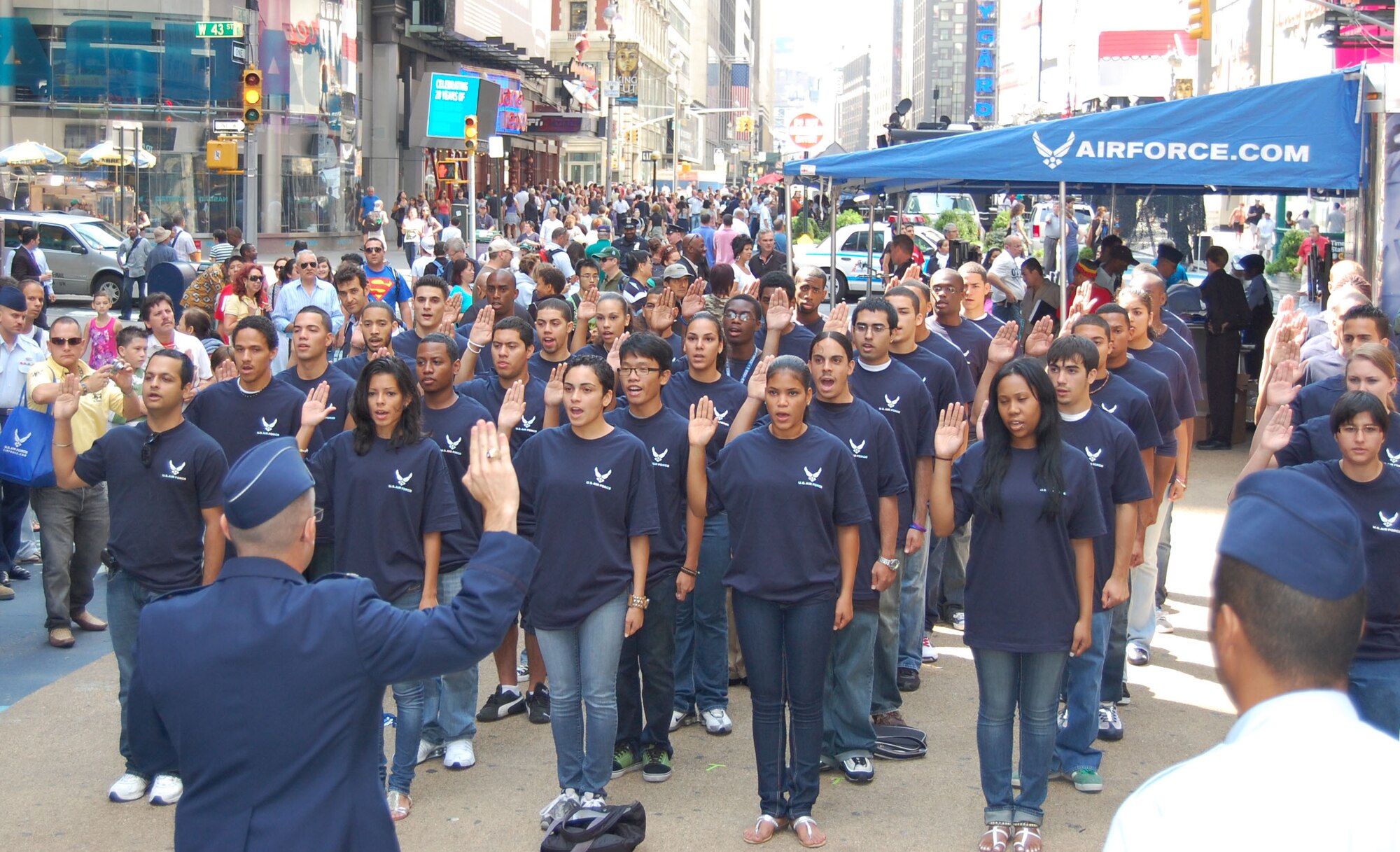 Lt. Col. Robert D. Roy, 313th Recruiting Squadron commander, swears in members of the Delayed Enlistment Program in Times Square Aug. 26, 2010, during Air Force Week in New York City. The day started with an appearance on the “Good Morning America” show. Air Force Recruiting assets on hand included the Engage Tour, Command Center Alpha, two Air Force Monster Trucks and the Orange County Chopper. “We're proud to showcase America's Air Force here in Times Square,” said Colonel Roy. (U.S. Air Force photo/Master Sgt. Steve Acevedo)