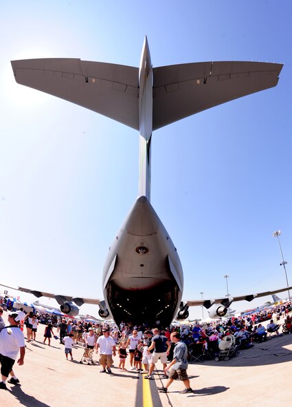 OFFUTT AIR FORCE BASE, Neb. - Crowds begin to form early at the 2010 Defenders of Freedom Open House and Air Show Aug. 28, as attendees find shade under the large wing of a C-17 while others get a peek inside.  The show gave the local community a rare chance to not only see the aircraft up close but also a chance to meet with military members. U.S. Air Force photo by Josh Plueger