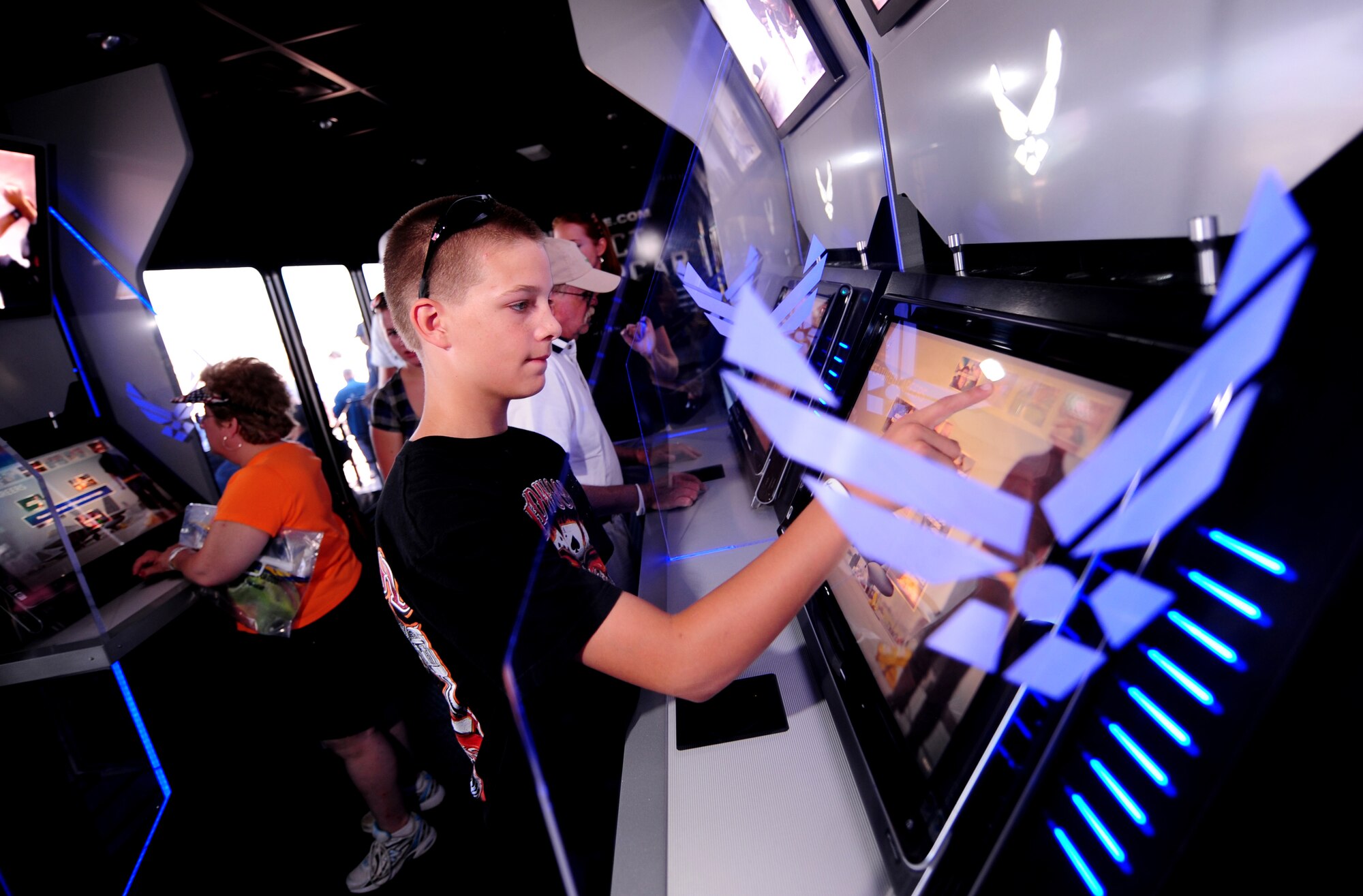 OFFUTT AIR FORCE BASE, Neb. - Cody Ray, an Omaha resident, walks through the Air Force recruiting display and uses touch screen panels to learn about the vast array of Air Force responsibilities Aug. 28 during the 2010 Defenders of Freedom Open House and Air Show. The show provided the local area community a rare chance to not only see aircraft up close but also to meet with military members. U.S. Air Force photo by Josh Plueger

